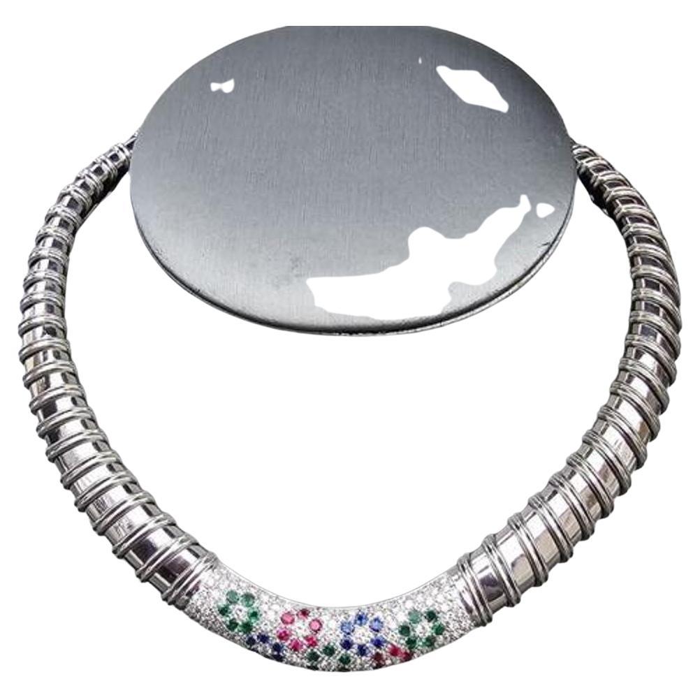 Elevate your jewelry collection with this stunning Roberto Coin Nabucco necklace. Crafted from 18k white gold, this choker style collar features a dazzling array of precious stones, including diamonds, rubies, emeralds, and sapphires. The exquisite