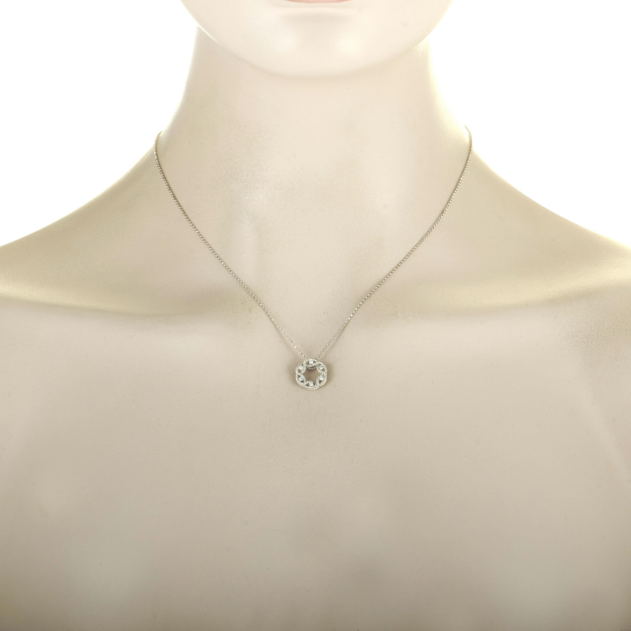The “New Barocco” necklace by Roberto Coin is crafted from 18K white gold and embellished with diamonds that amount to 0.10 carats. The necklace weighs 4.3 grams, boasting a 16” chain onto which a 0.45” by 0.45” pendant is attached.
 
 This item