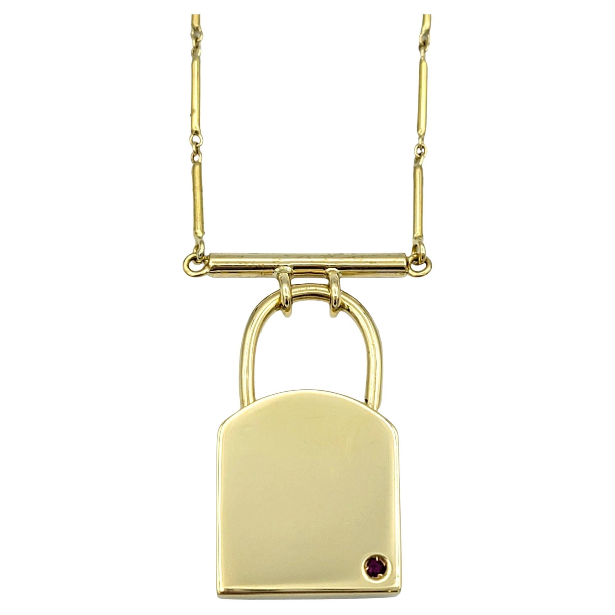This gorgeous Roberto Coin padlock design pendant necklace, crafted in luxurious 18 karat yellow gold, is a symbol of timeless sophistication. The pendant features a simple yet elegant padlock design, exuding a sense of security and charm. Suspended