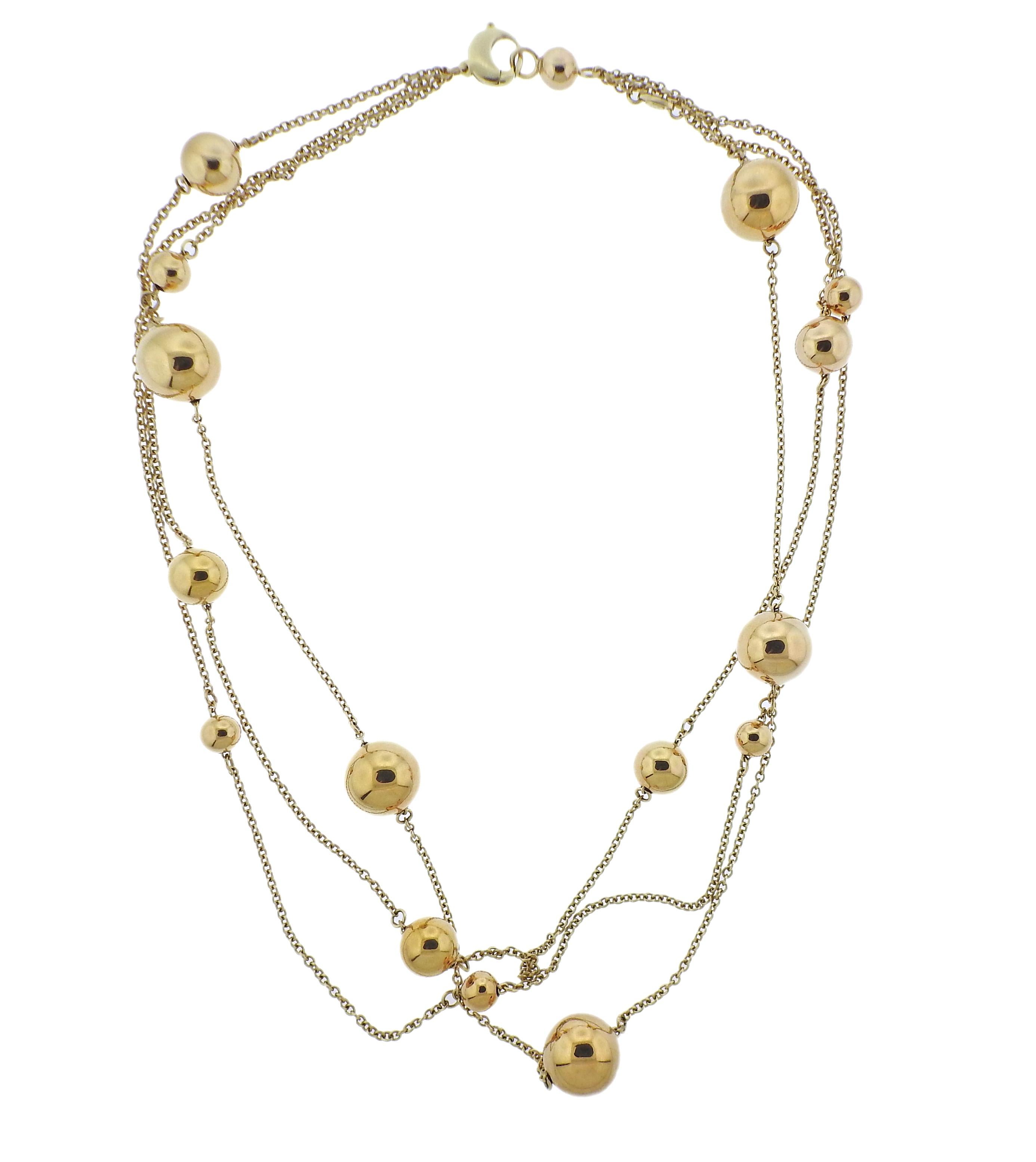 18k yellow gold Pallini ball station necklace by Roberto Coin. Necklace features 3 strands, with multi size balls. Necklace's wearable length is 22.5