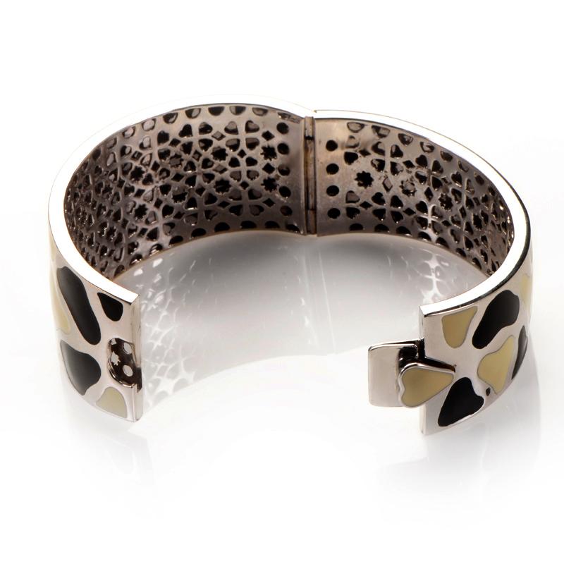 This bangle from Roberto Coin is playful and fun. It is made of 18K white gold and boasts a design of black and cream colored shapes.
