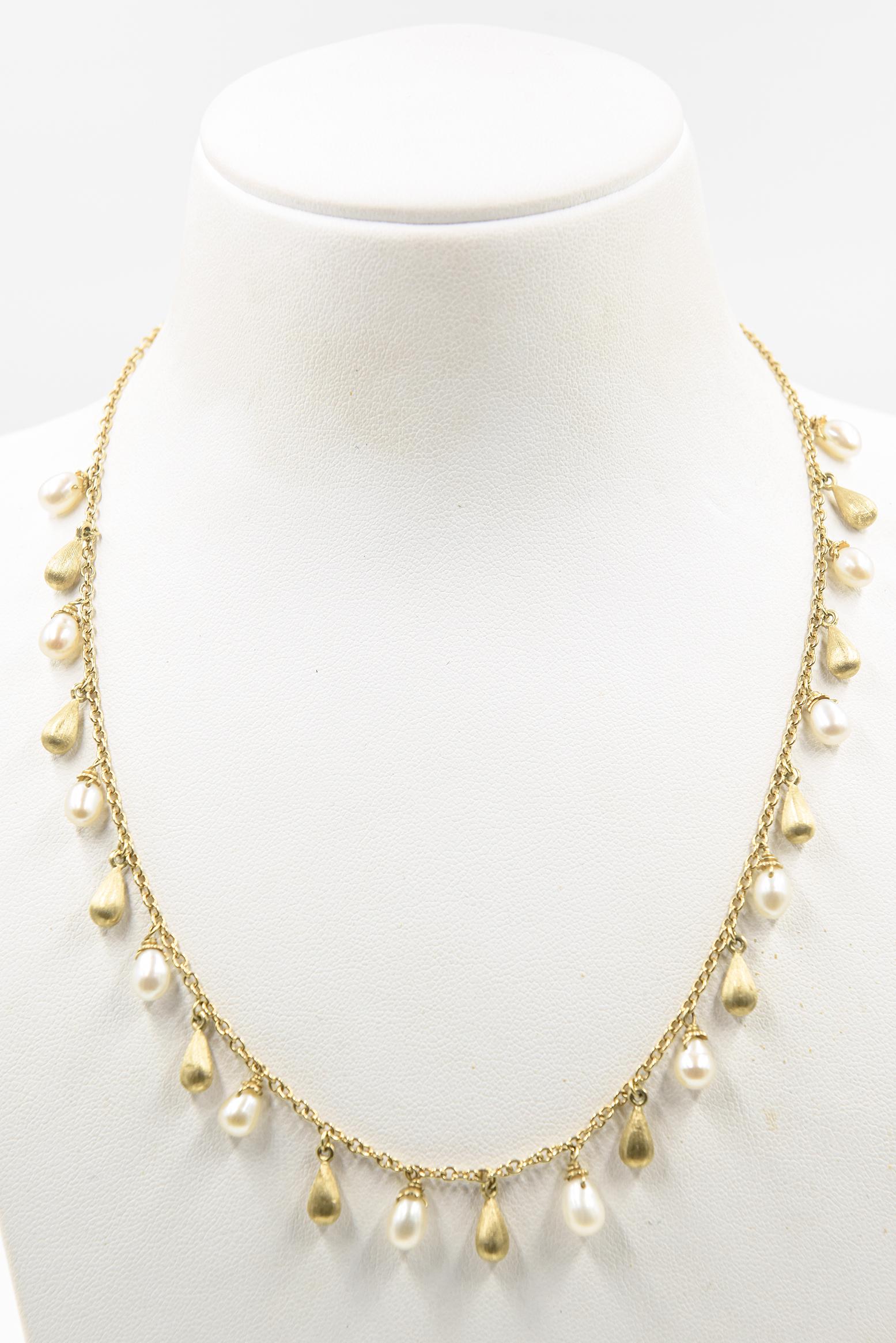 18K yellow gold Roberto Coin fringe necklace featuring oval cultured pearls and gold textured teardrops ornaments terminating in a lobster clasp closure.  The necklace is 16.25
