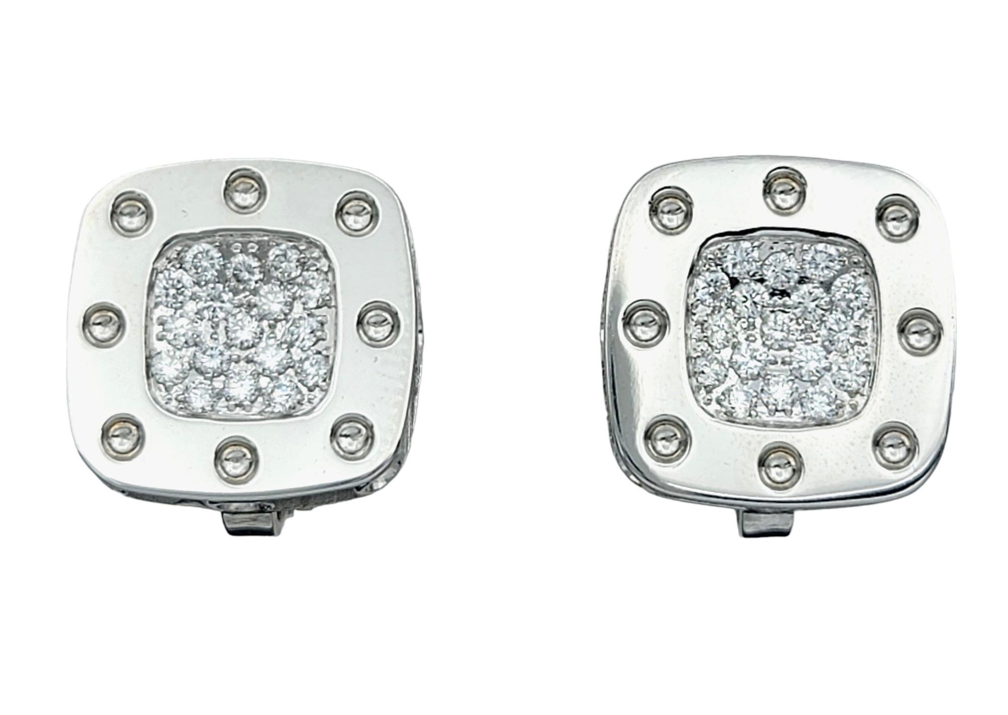 These Roberto Coin Pois Moi diamond omega back earrings are a dazzling addition to any jewelry collection. Crafted in 18 karat white gold, they feature the signature Pois Moi design, characterized by square indentations reminiscent of a playful