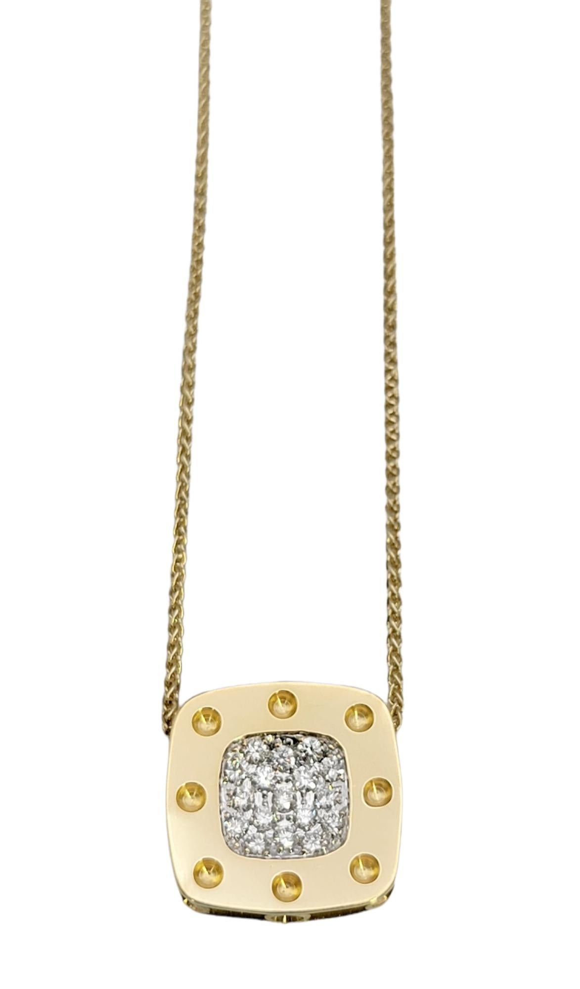 Pretty pave diamond pendant necklace by Roberto Coin. Simple, modern and chic, this piece features a polished yellow gold square pendant with circle accents and enhanced with glittering diamonds at the center. The pendant is 18 karat gold and is