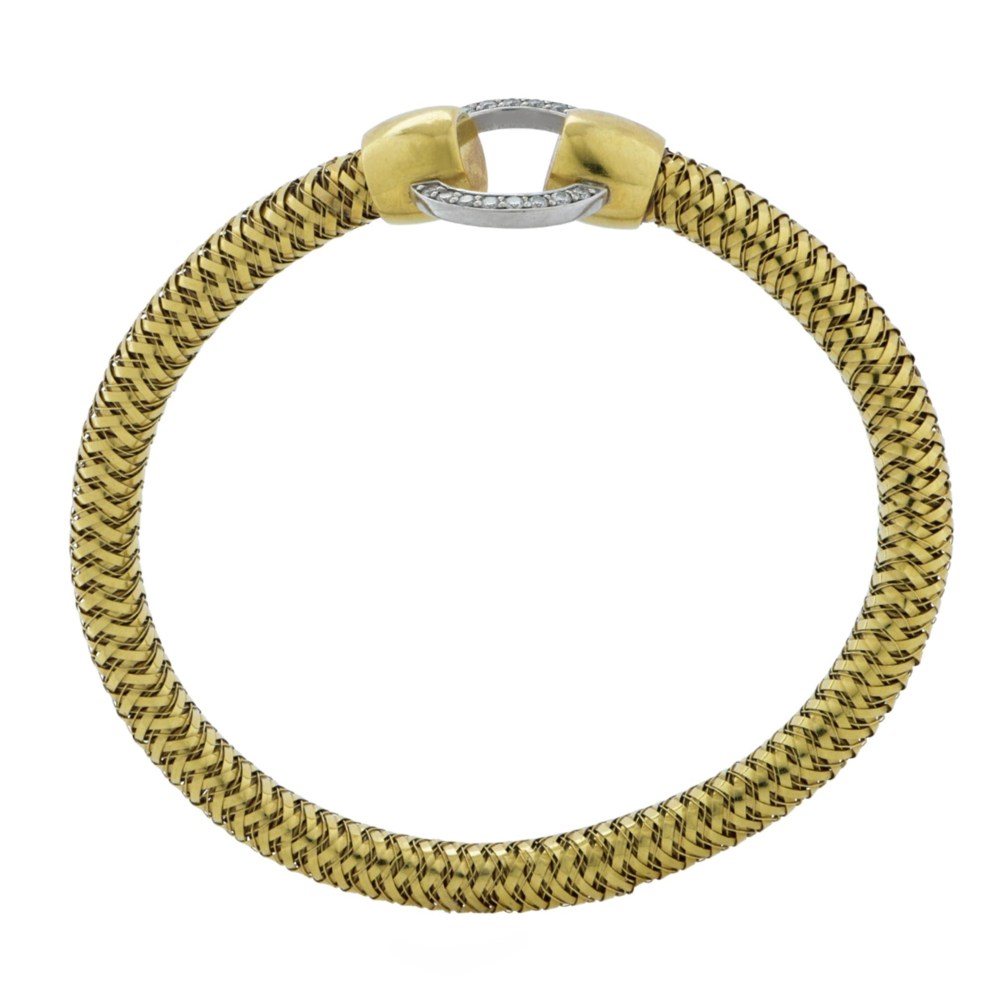 This classic bracelet from the Roberto Coin Primavera Collection, is crafted in 18 karat yellow and white gold, and features a flexible yellow gold chain, detailed with a diamond encrusted ring crafted in white gold, adorned with 16 diamonds,