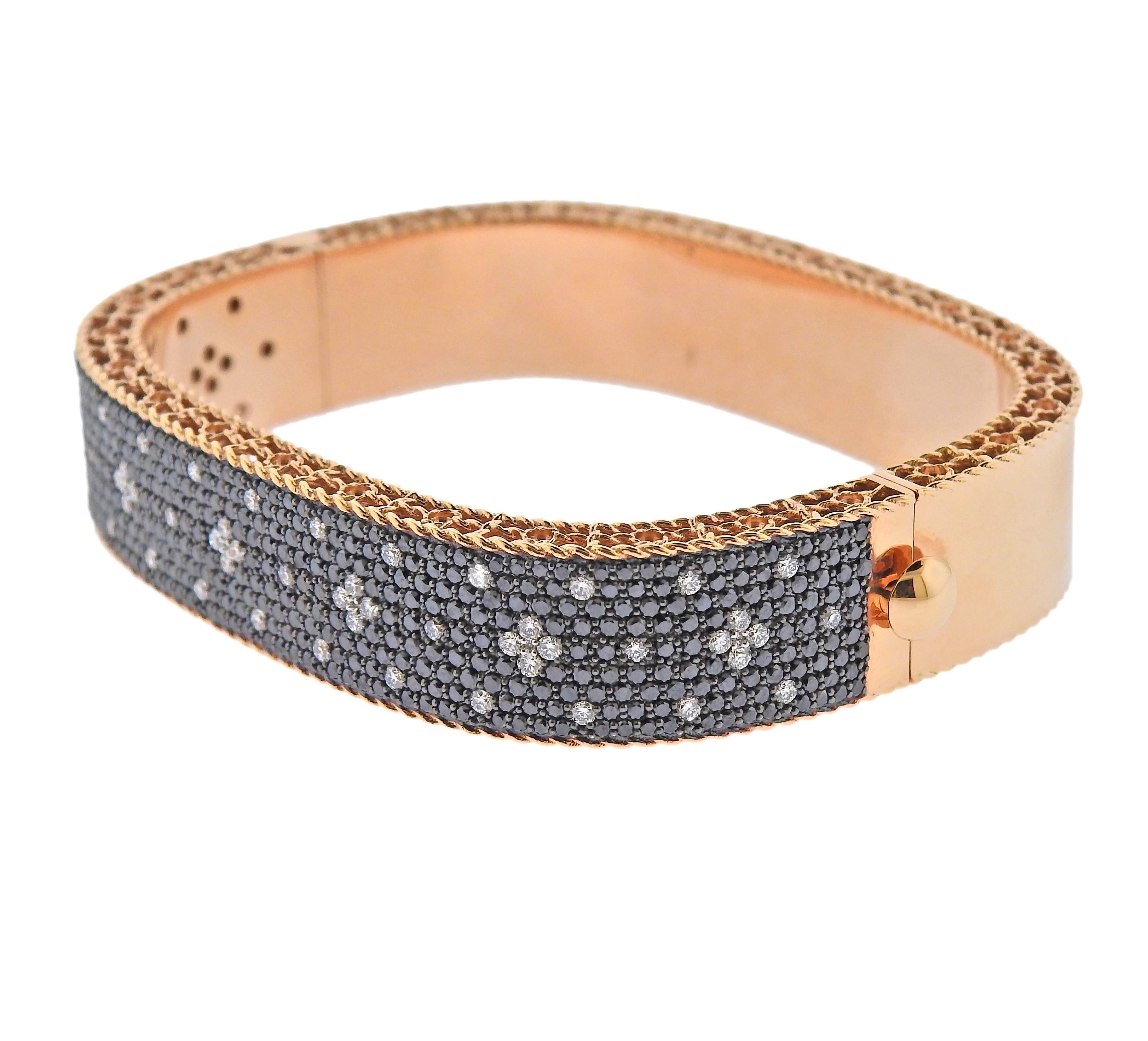 18k rose gold bracelet crafted by Roberto Coin. Set with a total of 5.02ctw in VS/G white diamonds and VS black diamonds. Retail is $18,000. Inside measures 46mm x 56mm, will comfortably fit 7