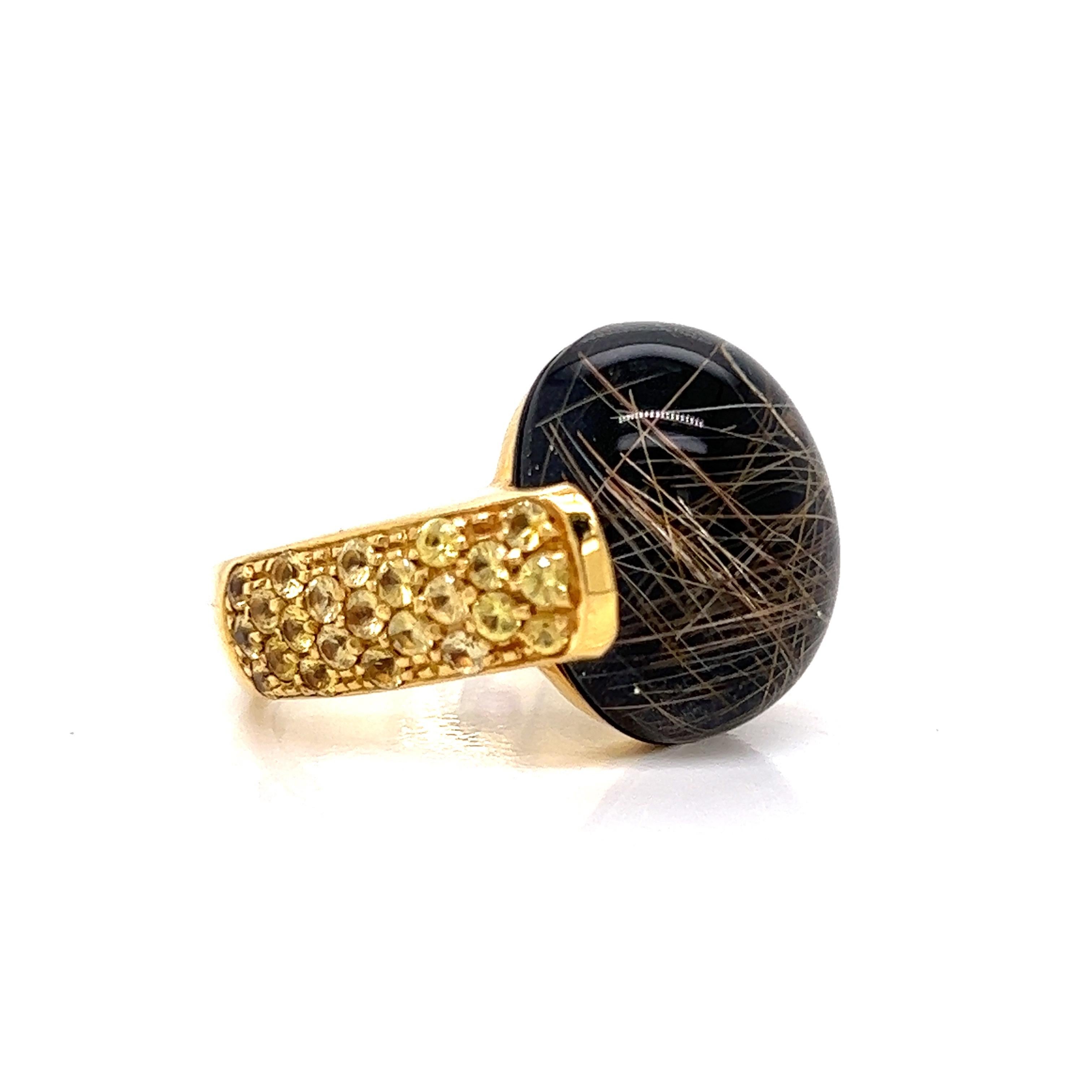 Italian Style! This Roberto Coin ring is unique and makes a fashion statement.  A large cabochon black rutilated quartz, approximately 2.70 ct is accentuated by 1.65 ctw in vibrant yellow sapphire.  Set in 10 grams of 18 Kt yellow gold.   Stamped,