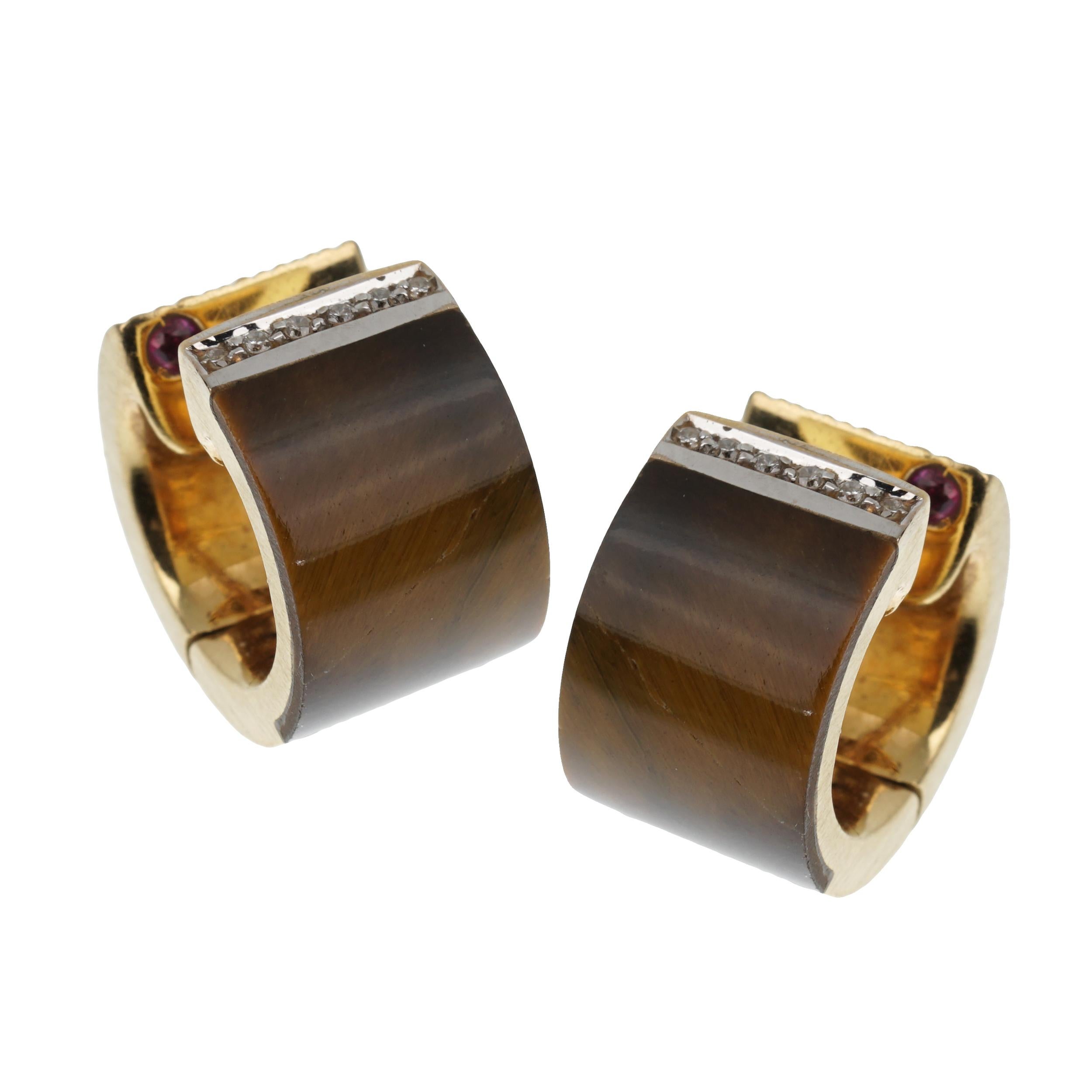 Roberto Coin Tiger Eye Vintage Diamond Gold Huggie Earrings that encapsulate the beauty of nature and the artistry of fine jewelry in one. These earrings are meticulously crafted to embody elegance and sophistication.

At the very pinnacle of each