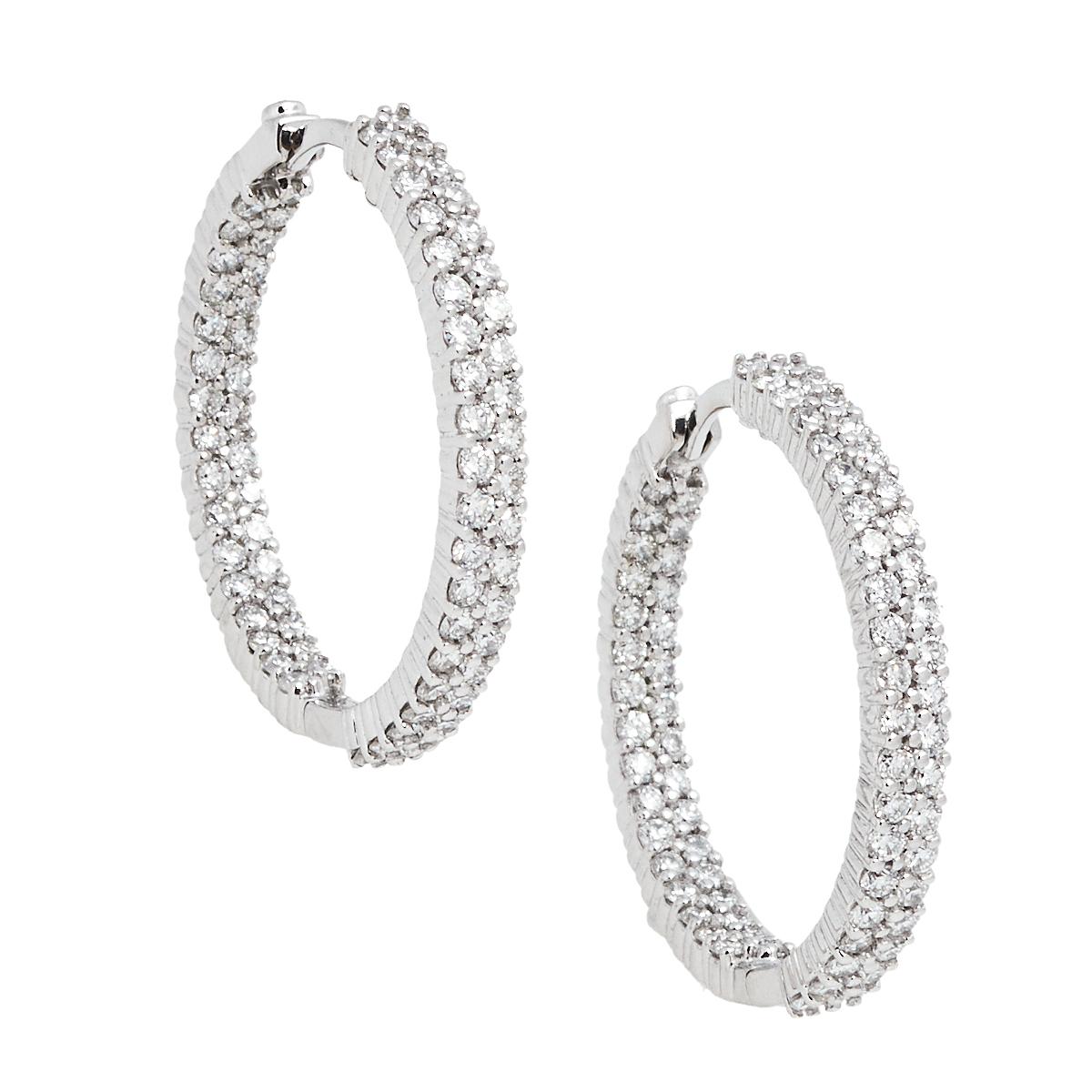 Roberto Coin flaunts the beauty of diamonds in these hoop earrings. The set comes shaped from 18k white gold and traced with brilliant-cut diamonds, each one shining with the other in harmony. The diamonds are all placed with a precision that once