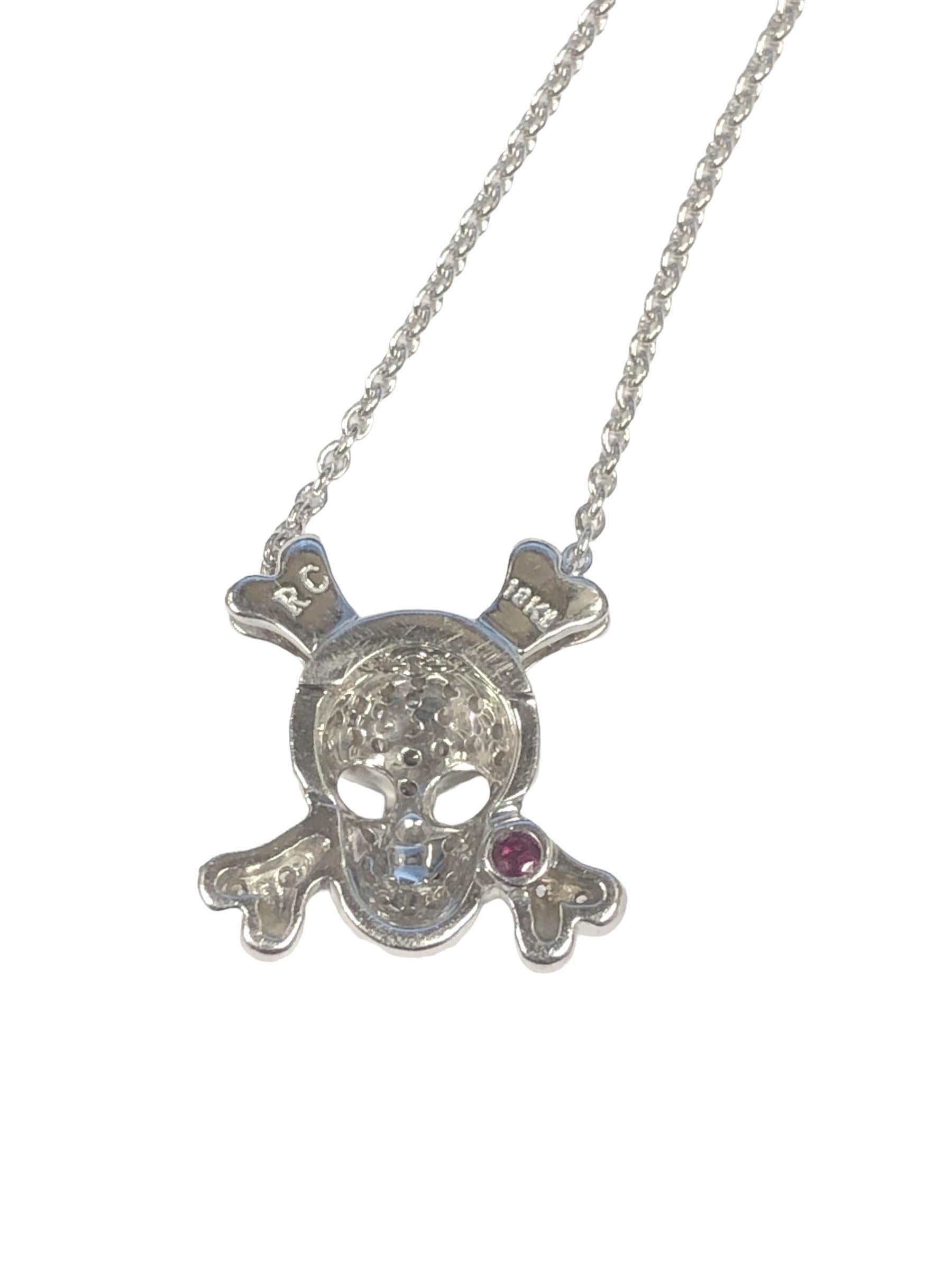 Circa 2020 Roberto Coin Tiny Treasures collection, 18k White Gold Skull and Cross Bones Pendant Necklace. Measuring 1/2 x 1/2 inch and suspended from an 18 inch chain, set with .20 Carat of Round Brilliant cut Diamonds. 
