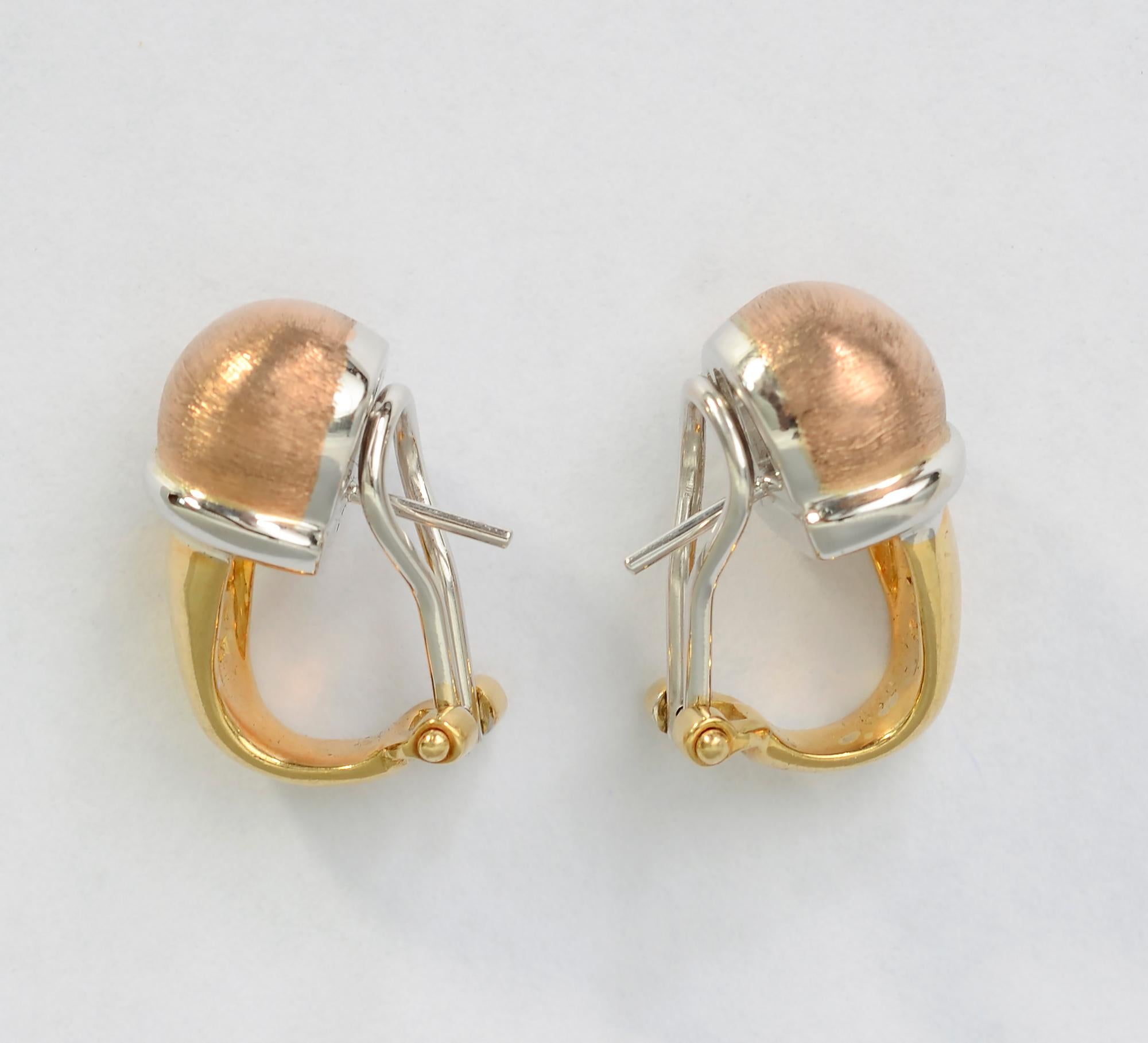 Unusual tricolor 18 karat gold earrings by Robert Coin. The rose gold bulb on top has a brushed finish with a gloss finish to the yellow and white gold . Backs are clips and posts.
While Coin is known for the hidden ruby used as part of his
