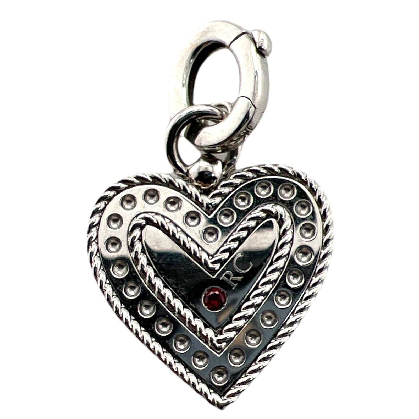 Diamond heart pendant by designer Roberto Coin fashioned in satin finish 18 karat white gold. The heart features 15 round brilliant cut diamonds weighing .30 CTW and graded F-G color and VS clarity. The heart is medium size measuring 30mm in length