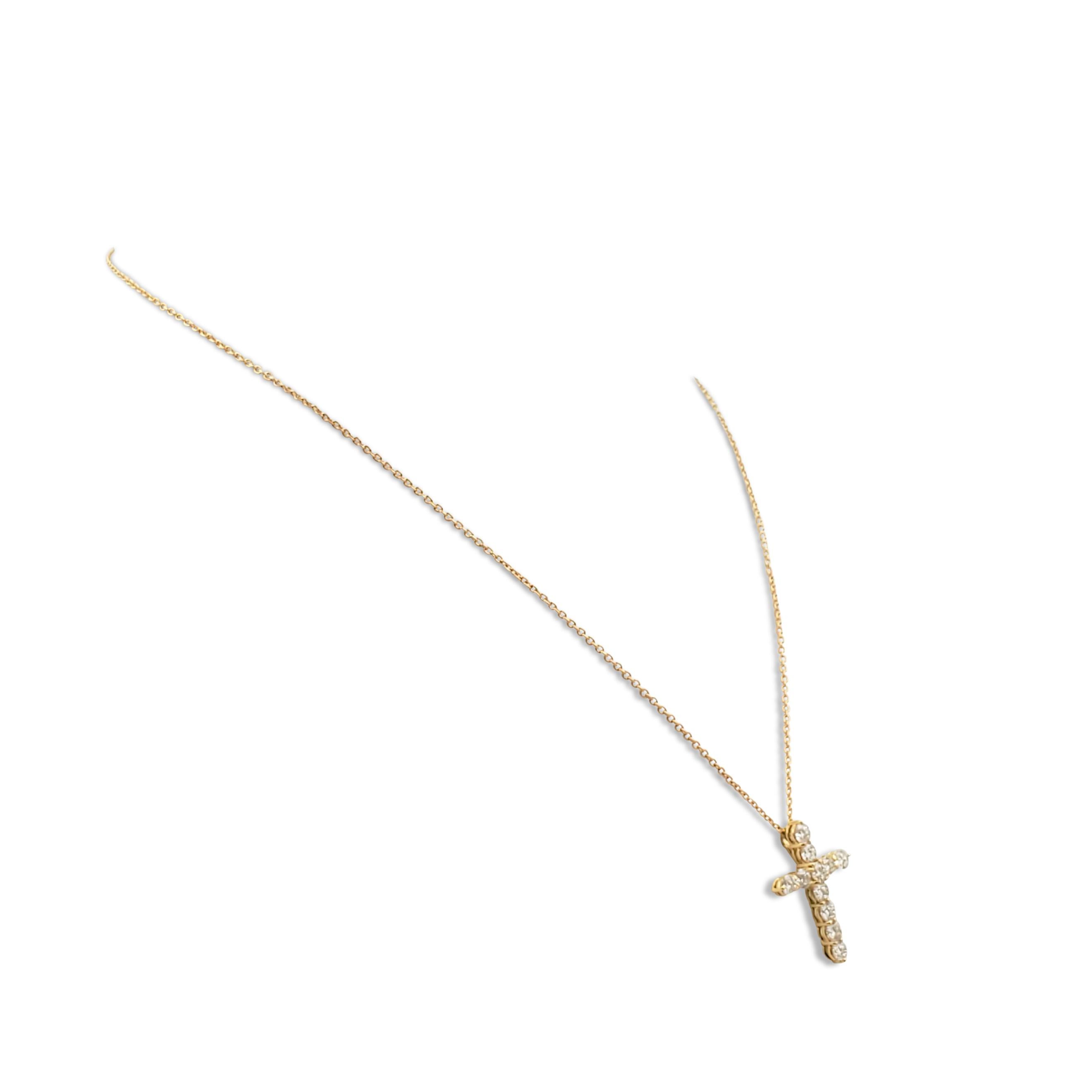 Authentic Roberto Coin cross pendant crafted in 18 karat yellow gold and set with an estimated 1.77 carats of round brilliant cut diamonds (G-H, SI). The pendant hangs from a delicate rolo chain with a lobster clasp. Signed RC, 750 with Roberto Coin