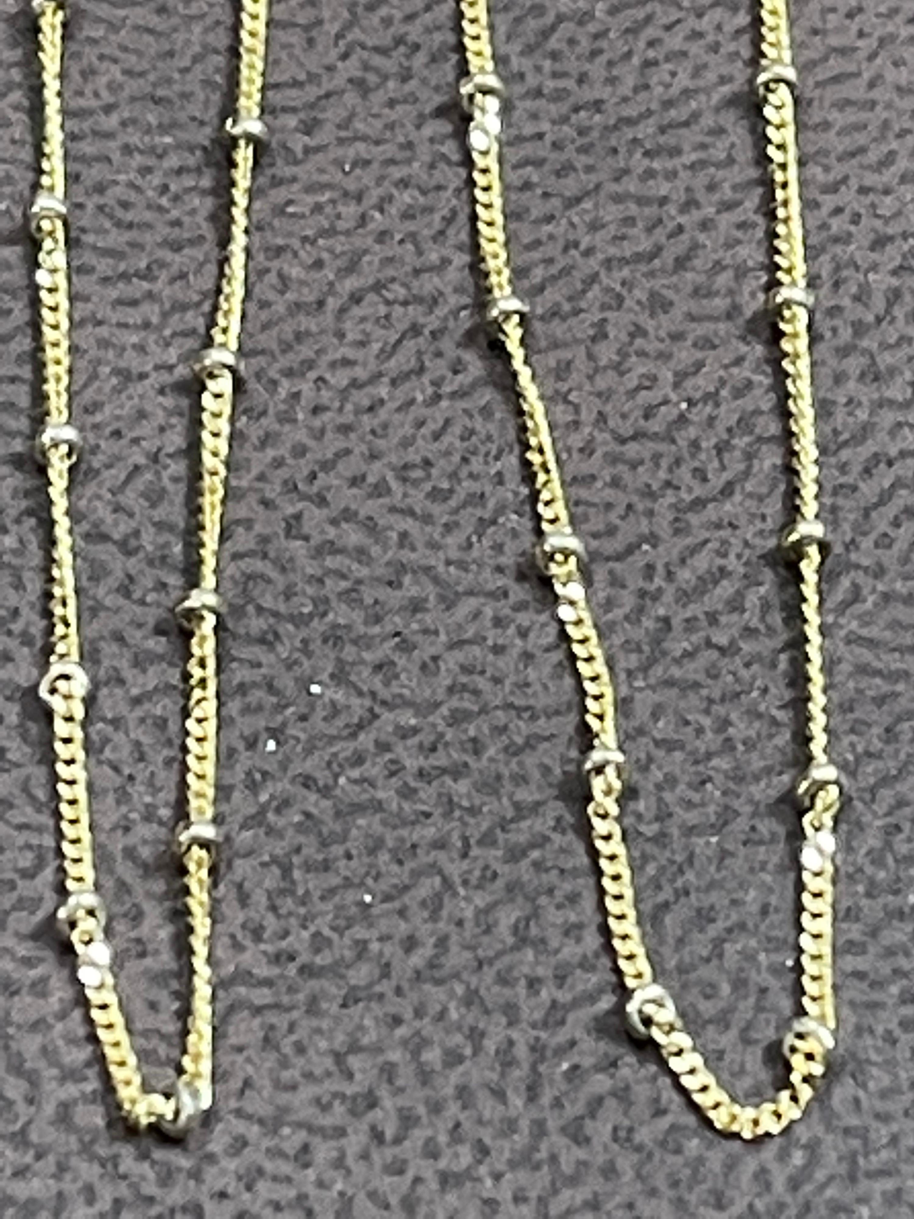 Marked 1226VI
14 K , Italy
It can be used for any pendant to make it more beautiful. Small round lobster clasp. 
Simple yet elegant, this 14k yellow gold necklace allures with its minimalistic design. Glorious round multi tiny balls/rings all over
