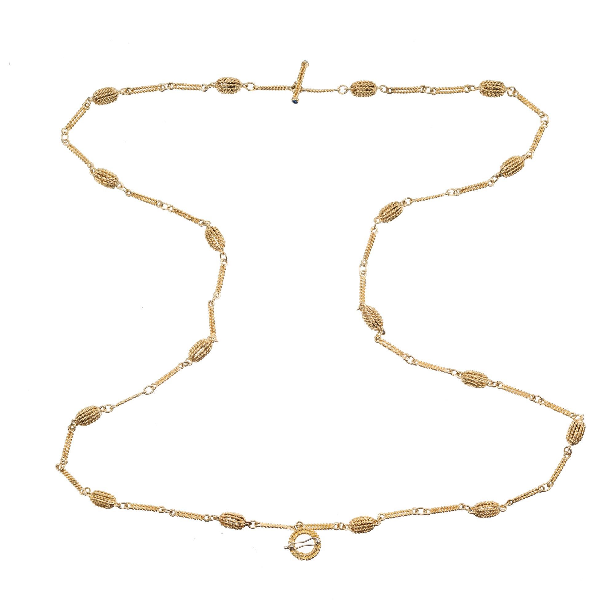 Roberto Coin Yellow Gold Two Strand Twisted Wire Necklace. The strand of this piece are delicately twisted together, creating a stunning and unique design. Crafted in 18k  yellow gold, this necklace has alternating wire baskets and wire separators.