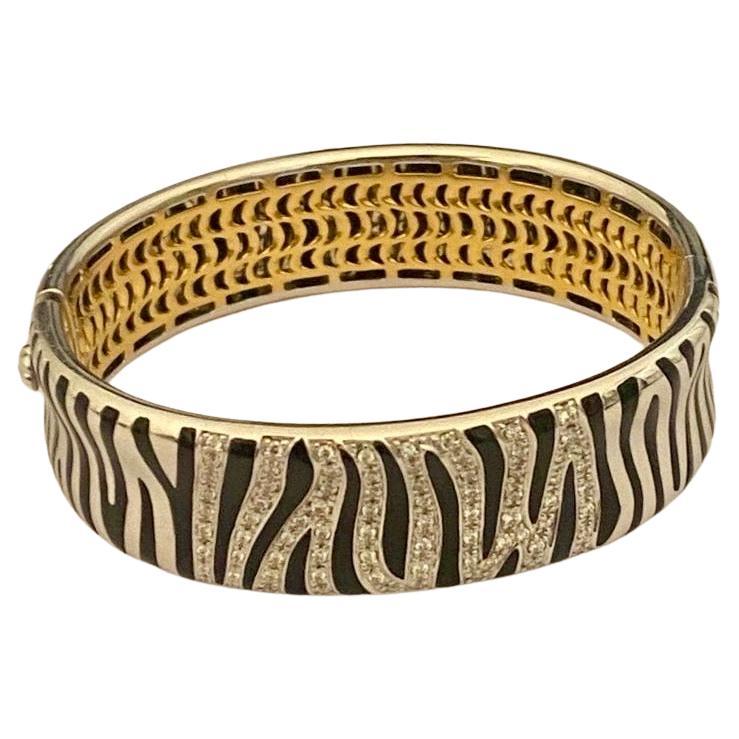 Striking Designer Robert Coin Diamond and Black Enamel Zebra collection bangle. Hand crafted in 2-tone 18 Karat Yellow and Whiter Gold with Diamond encrusted front. This piece has a wonderful, old-world charm. Set with Natural Round Brilliant cut