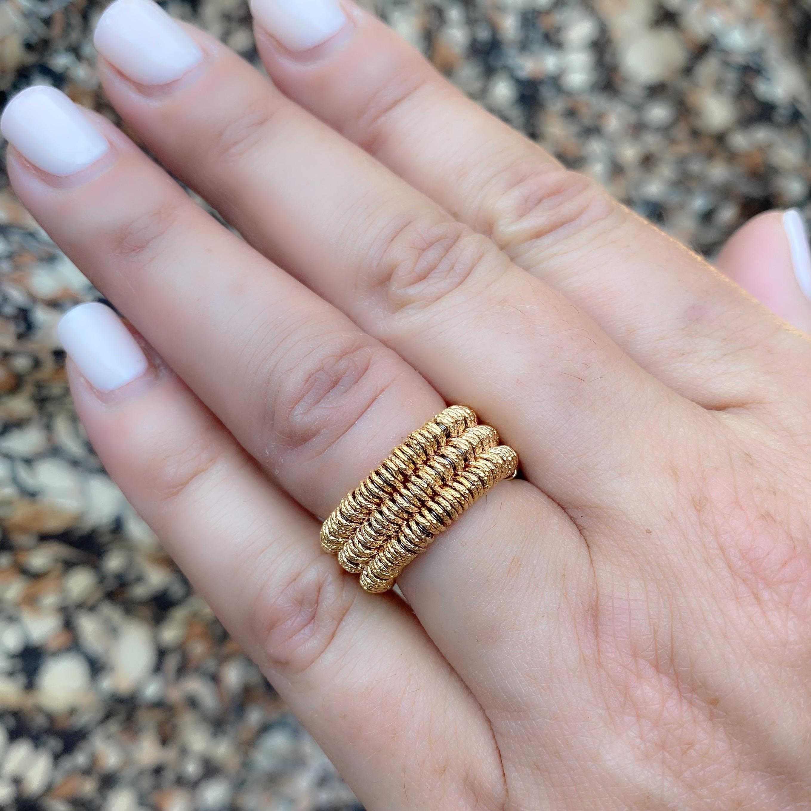 Made in Italy, from his JOY collection, this Demeglio 18k rose gold stretch ring is designed with three rows of textured links. It weighs 10.3 grams, and is size 5.5, with some stretch up. This ring has never been worn, and had an original retail of