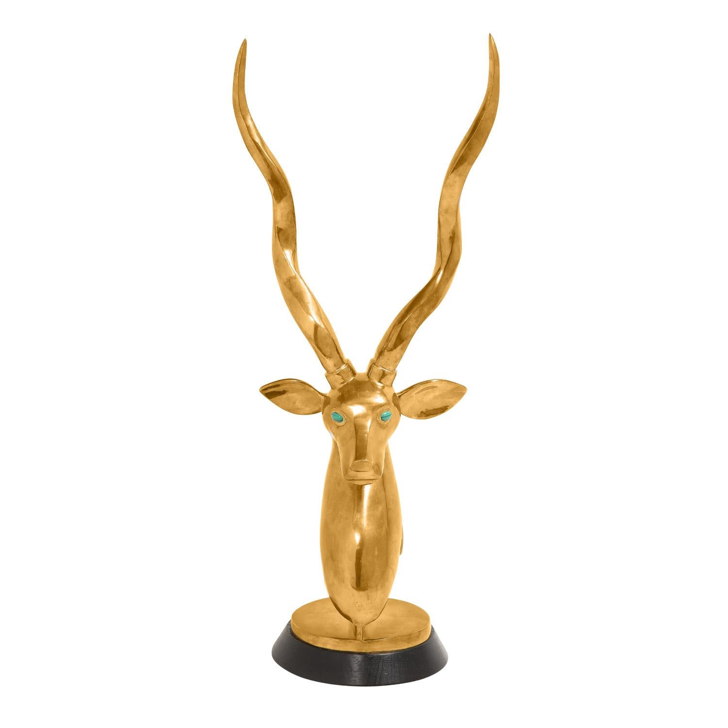 Kudu sculpture in polished brass with malachite eyes on dark wood base by Robert Estevez, American 1980's. The radiant malachite eyes set against the shimmering brass are a sight to behold. 

Roberto Estevez was an extremely talented jewelry