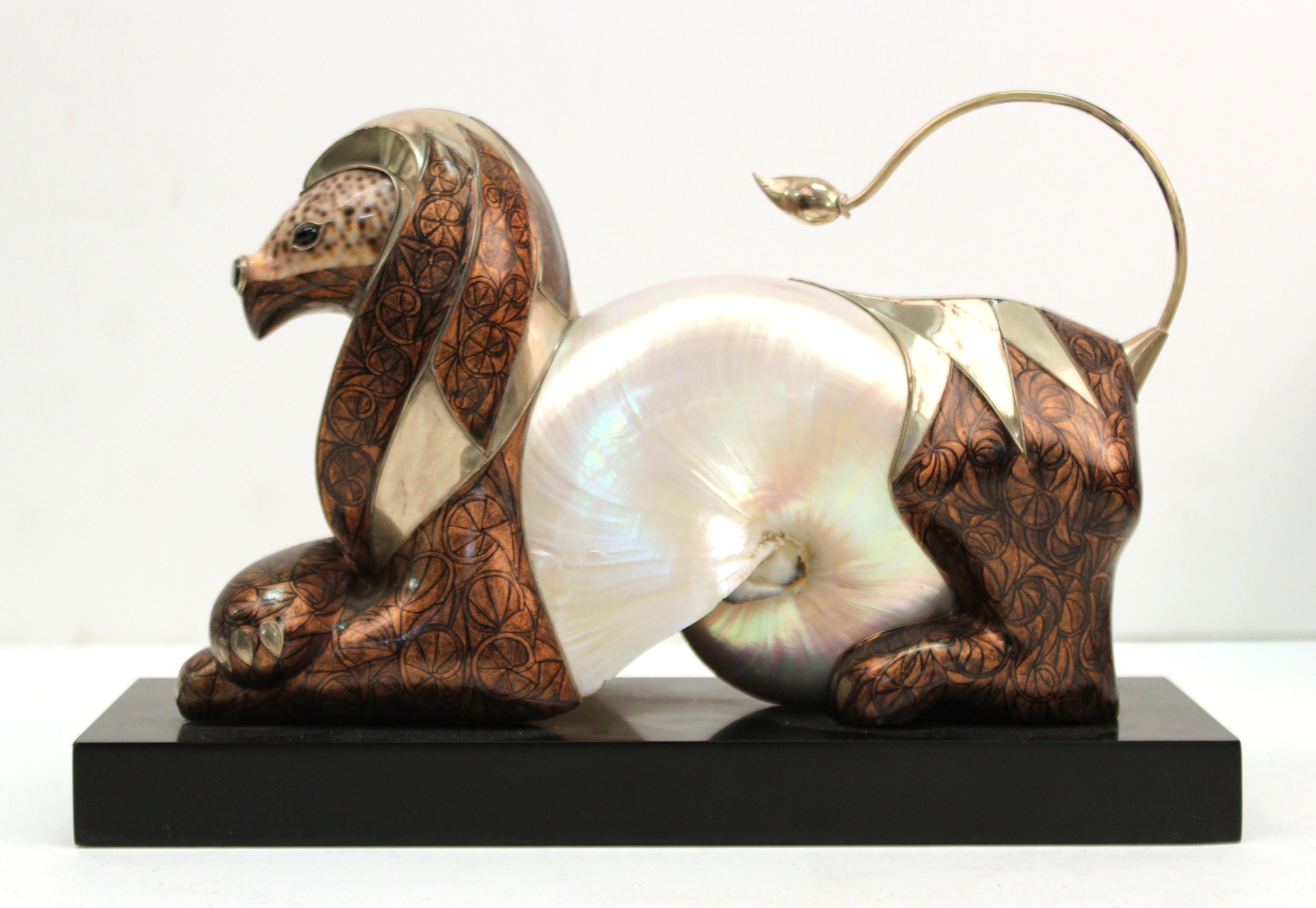Modern lion or griffin sculpture with shell body and head, made by Roberto Estevez. The piece has shell elements incorporated into the body and has metal inlay elements and hand painted surfaces. The piece was likely made in the circa 1970s by