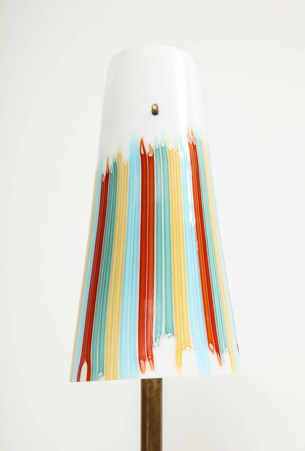 Unique table lamp by Roberto Giulio Rida.
Irregular chunk of brilliant turquoise-colored glass. Vintage, Venini glass cone shade, and finial. One candelabra socket and satin brass mounts.
