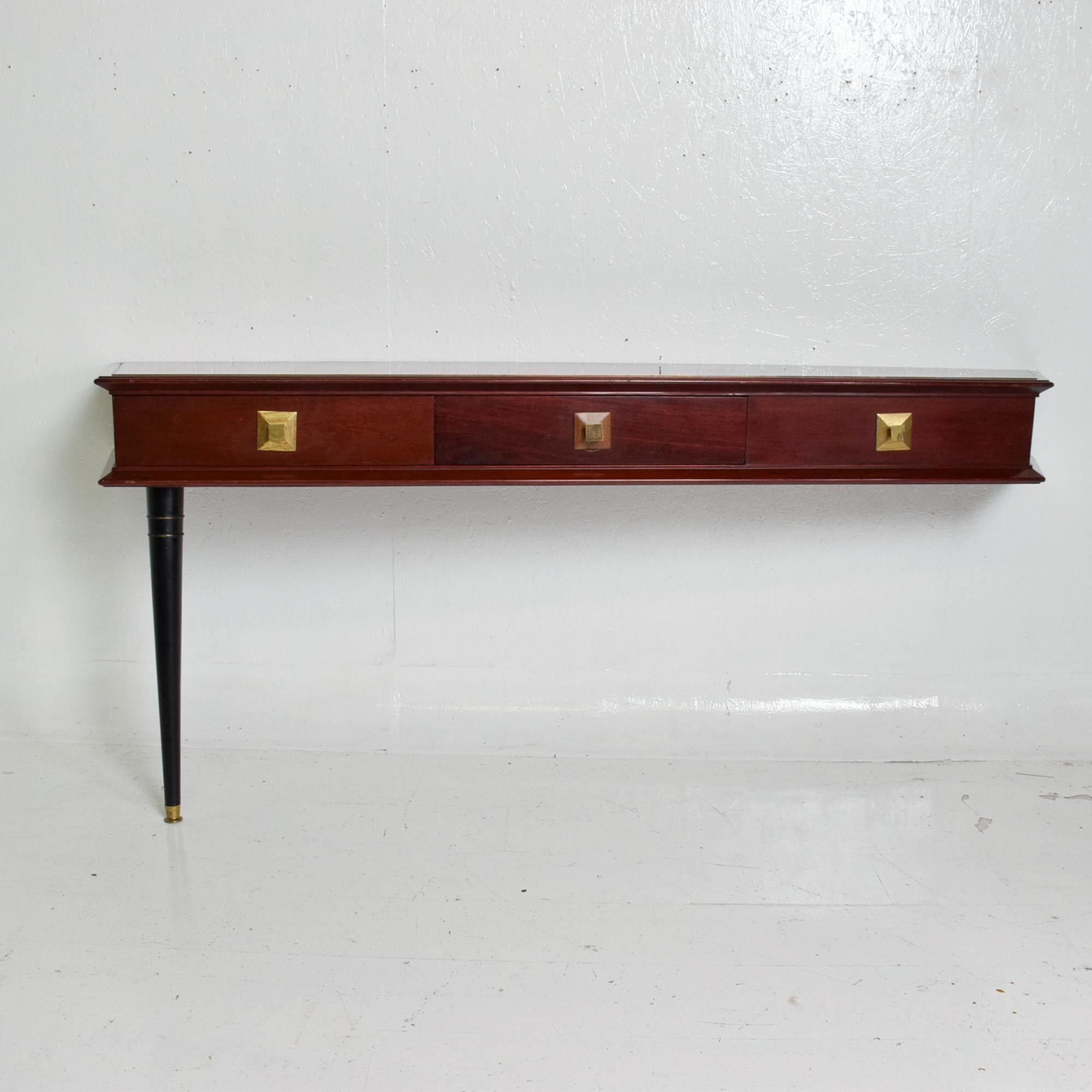 Mahogany wall console table desk designed by Robert & Mito Block.
Made in Mexico 1940s. 
Unmarked. 
Solid mahogany wood. Drawers with double dovetail joints.
Pull handles in brass original patina. Functioning drawers. Brass tip on leg.
The console