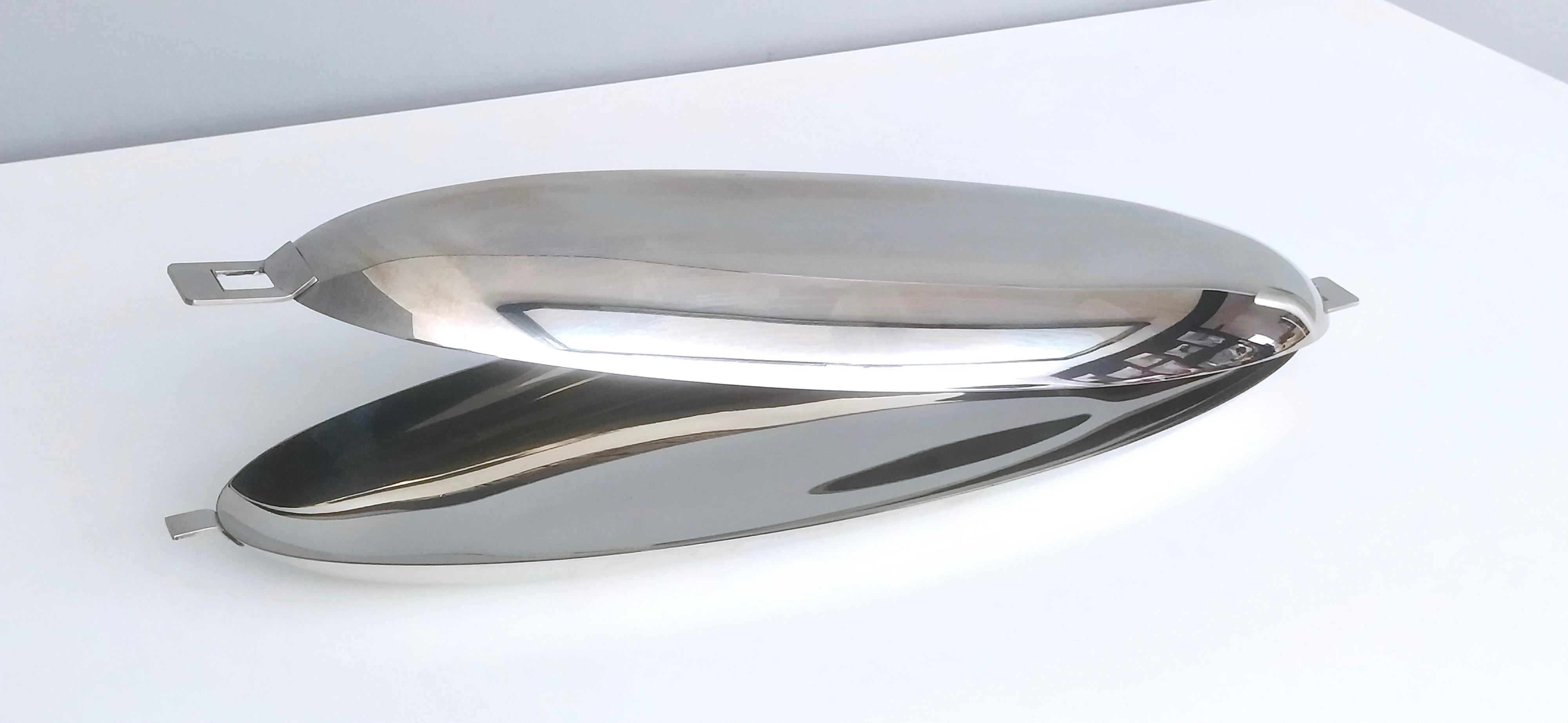 This is an elegant stainless steel fish poacher by Roberto Sambonet for Sambonet. It is perfect to serve and Cook fish, but also other dishes. 
It has a beautiful shell shape and the two halves are designed to provide three different opening
