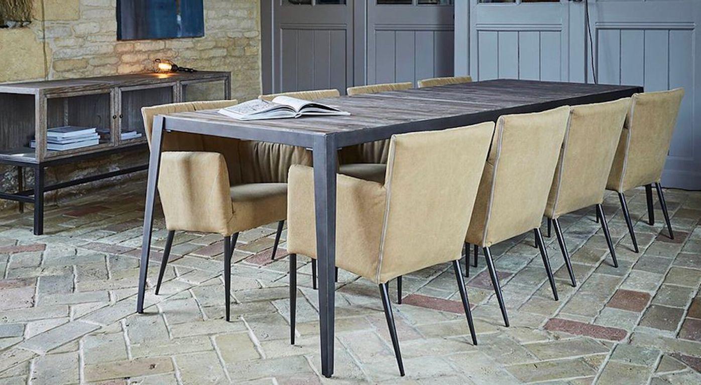 A stunning Roberts contemporary dining table, 20th century. This Japanese inspired large dining room table manufactured with angled steel construction boasts an acacia styled wooden top. The table comes with easily detachable legs and adjustable