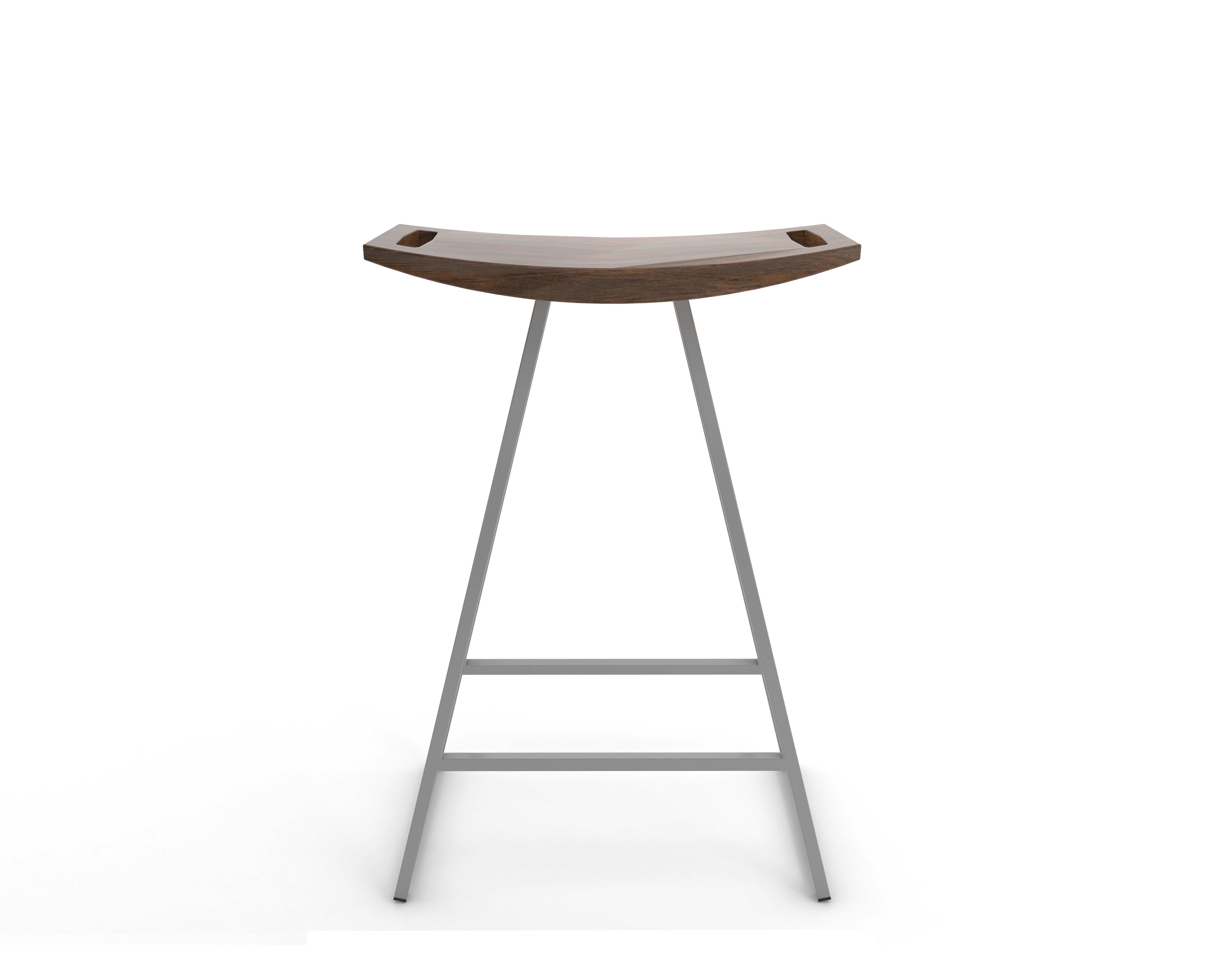 This sleek stool has a thin carved wooden seat that rests on a steel tubing base. The elegant seat is curved for seamless comfort while displaying a stunning intersecting diagonal accent inlay. This eye-catching and durable piece will make any