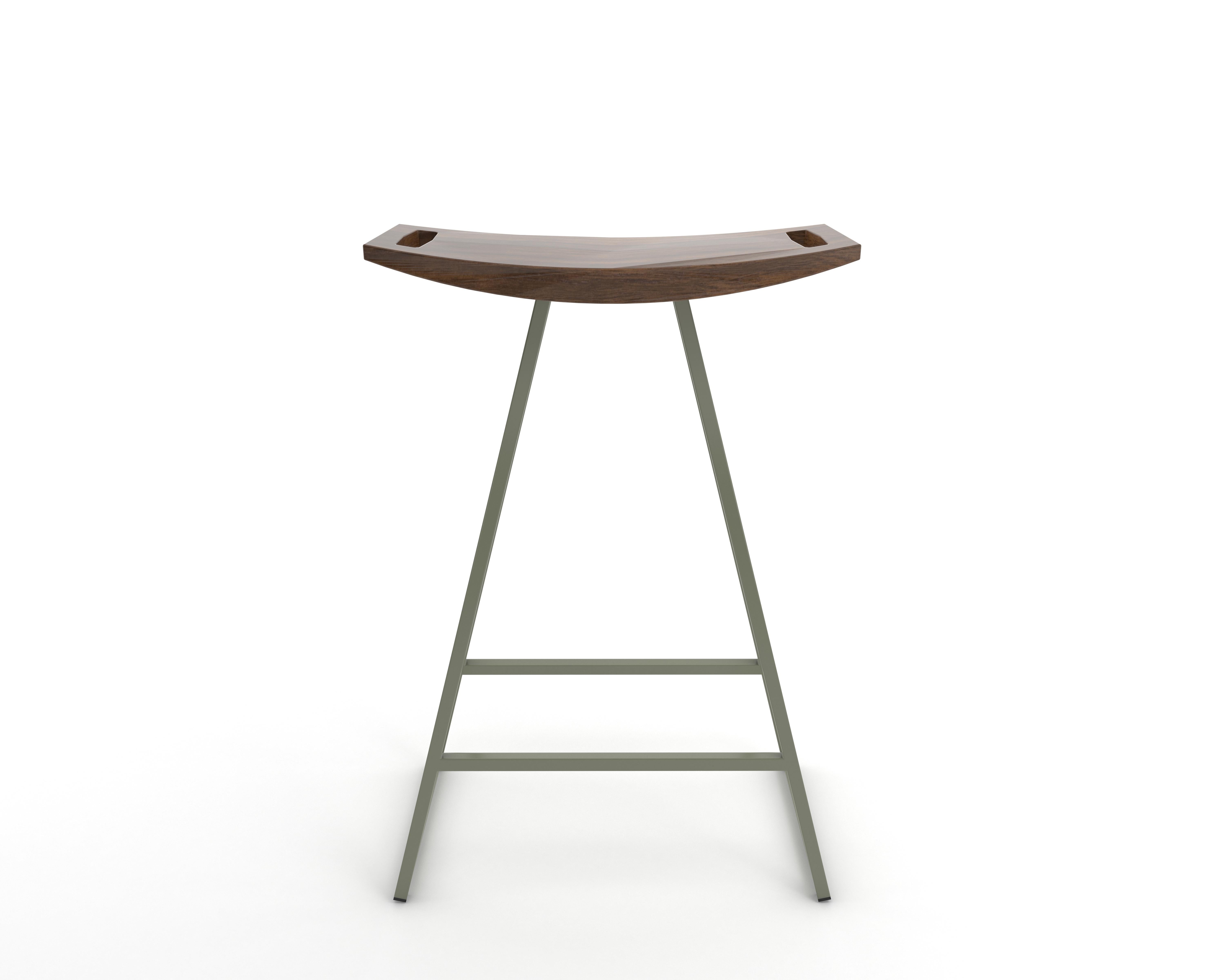 This sleek stool has a thin carved wooden seat that rests on a steel tubing base. The elegant seat is curved for seamless comfort while displaying a stunning intersecting diagonal accent inlay. This eye-catching and durable piece will make any