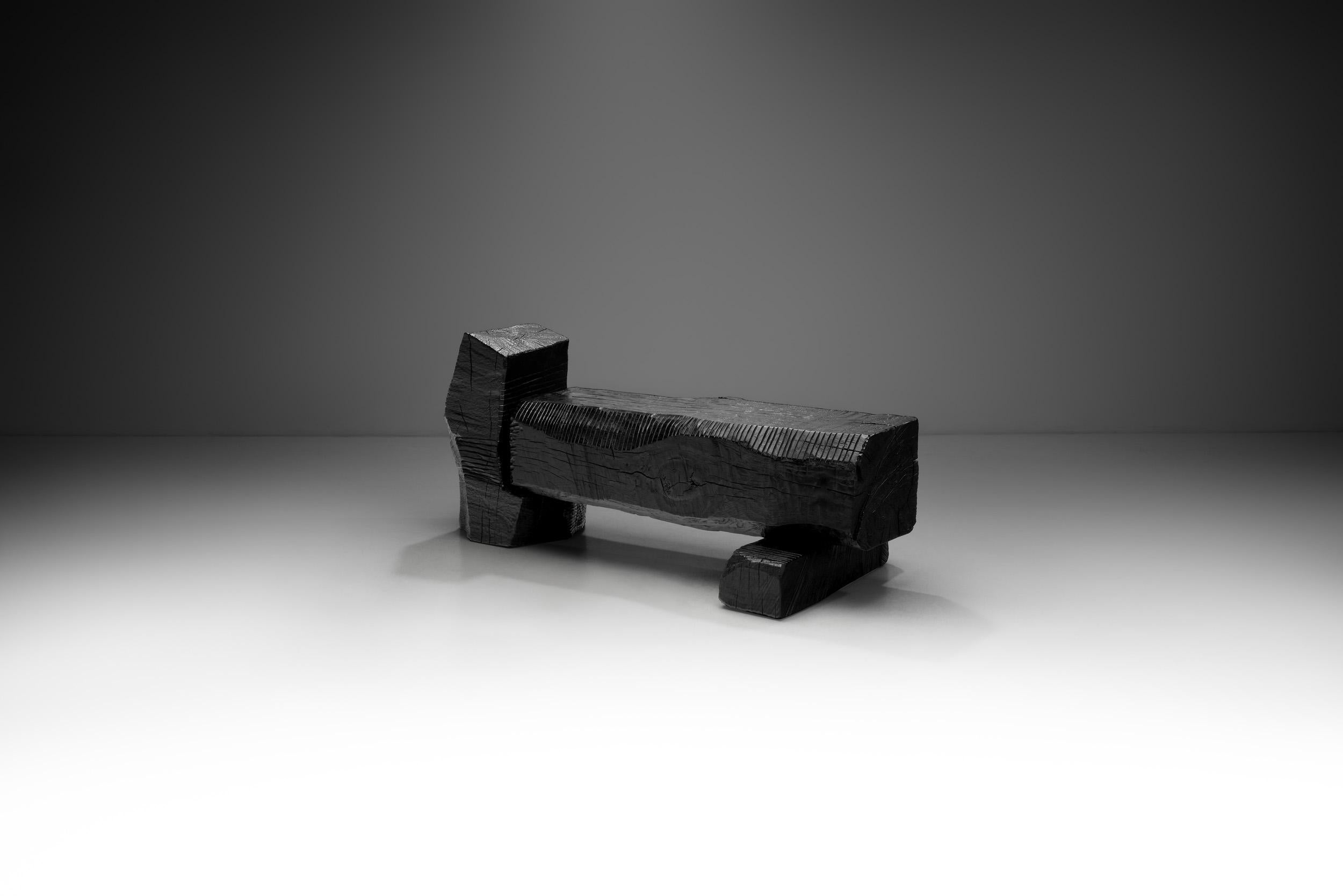 Robin Berrewaerts’s black oak bench is hand-sculpted and made of ebonized oak with an oil finish. Each piece is a unique expression, attacking the wood with the appropriate tools and finding by slow sensuous manipulation the best aesthetic effect,