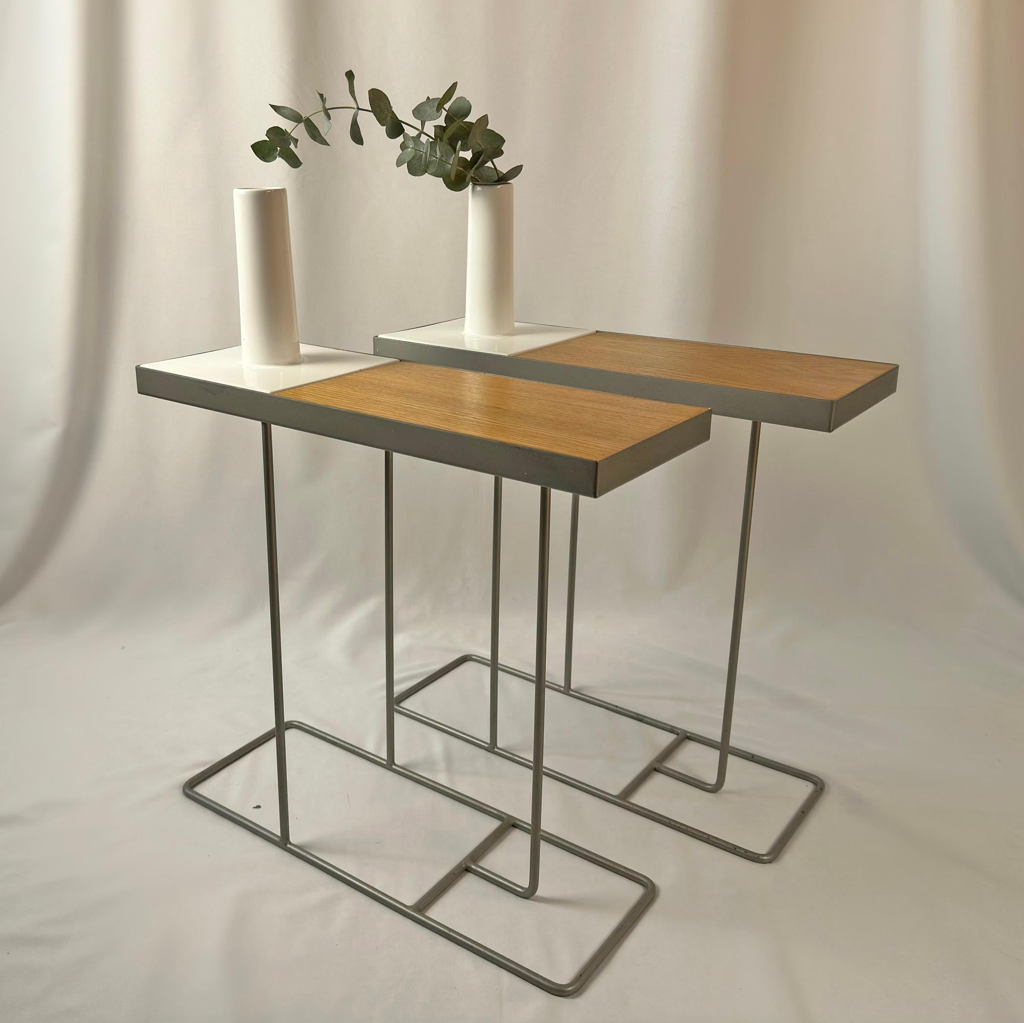 Introducing a pair of 'Iconic' Companion tables by the renowned designer Robin Day for Habitat. Originally designed in the mid-20th century, this timeless piece was re-issued in the 2000s with a modern twist, now featuring an elegant white ceramic
