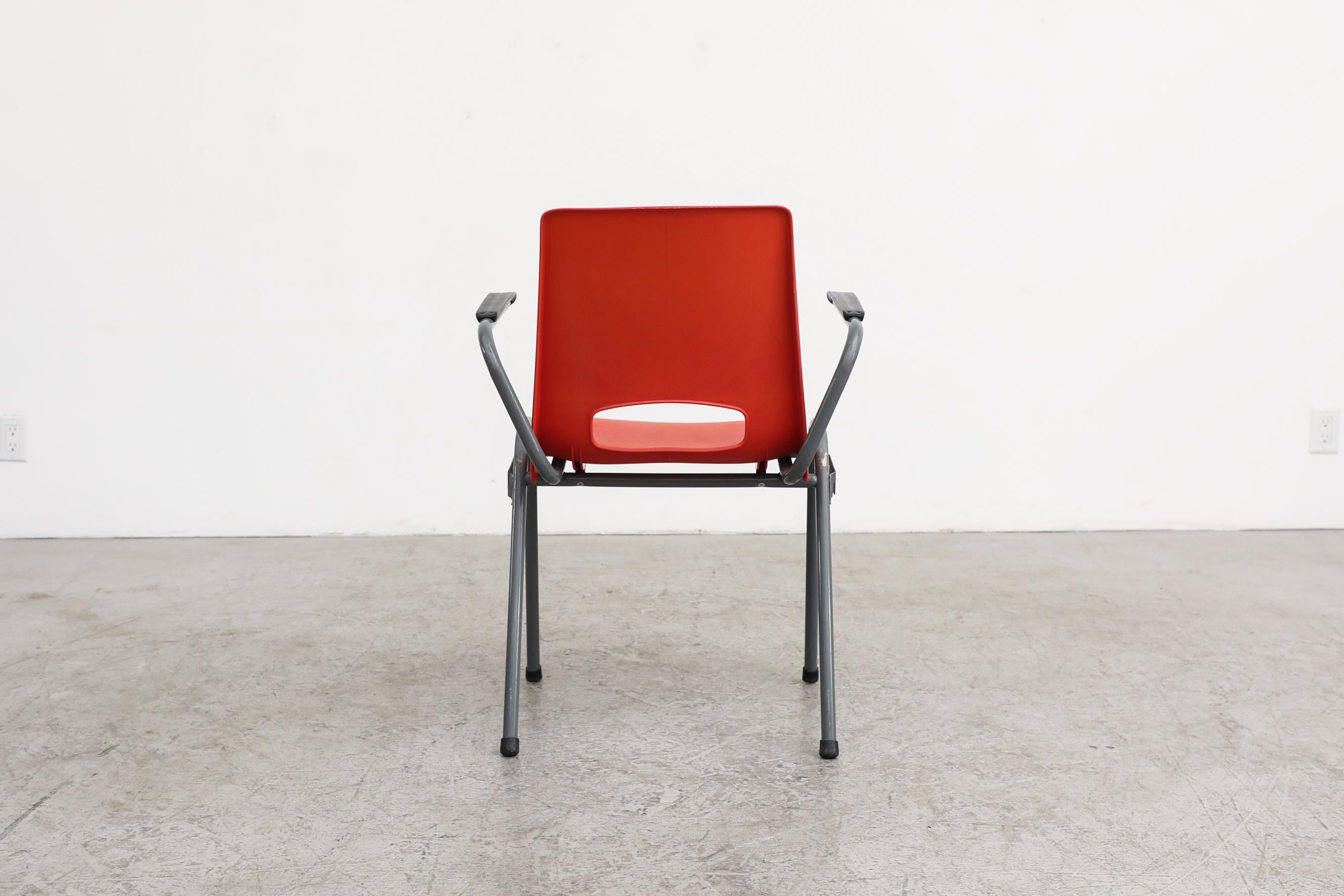 20th Century Robin Day Inspired Red Plastic Stacking Arm Chairs with Gray Metal Legs For Sale