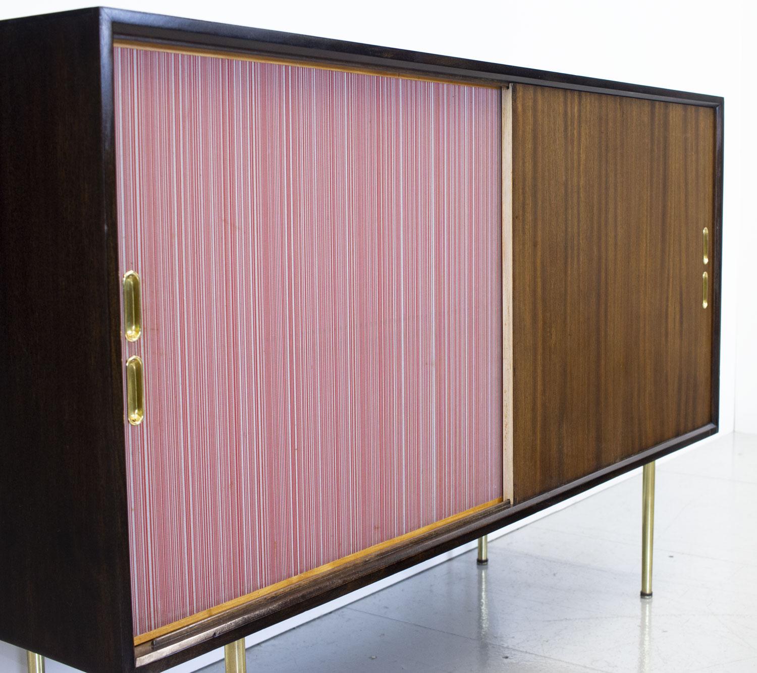 A rare 1950s sideboard designed by Robin Day as part of the Utility range for Heals department store in London and exhibited in the Home and Gardens Pavilion at the Festival of Britain in 1951. The range came in ash and mahogany but this unusual