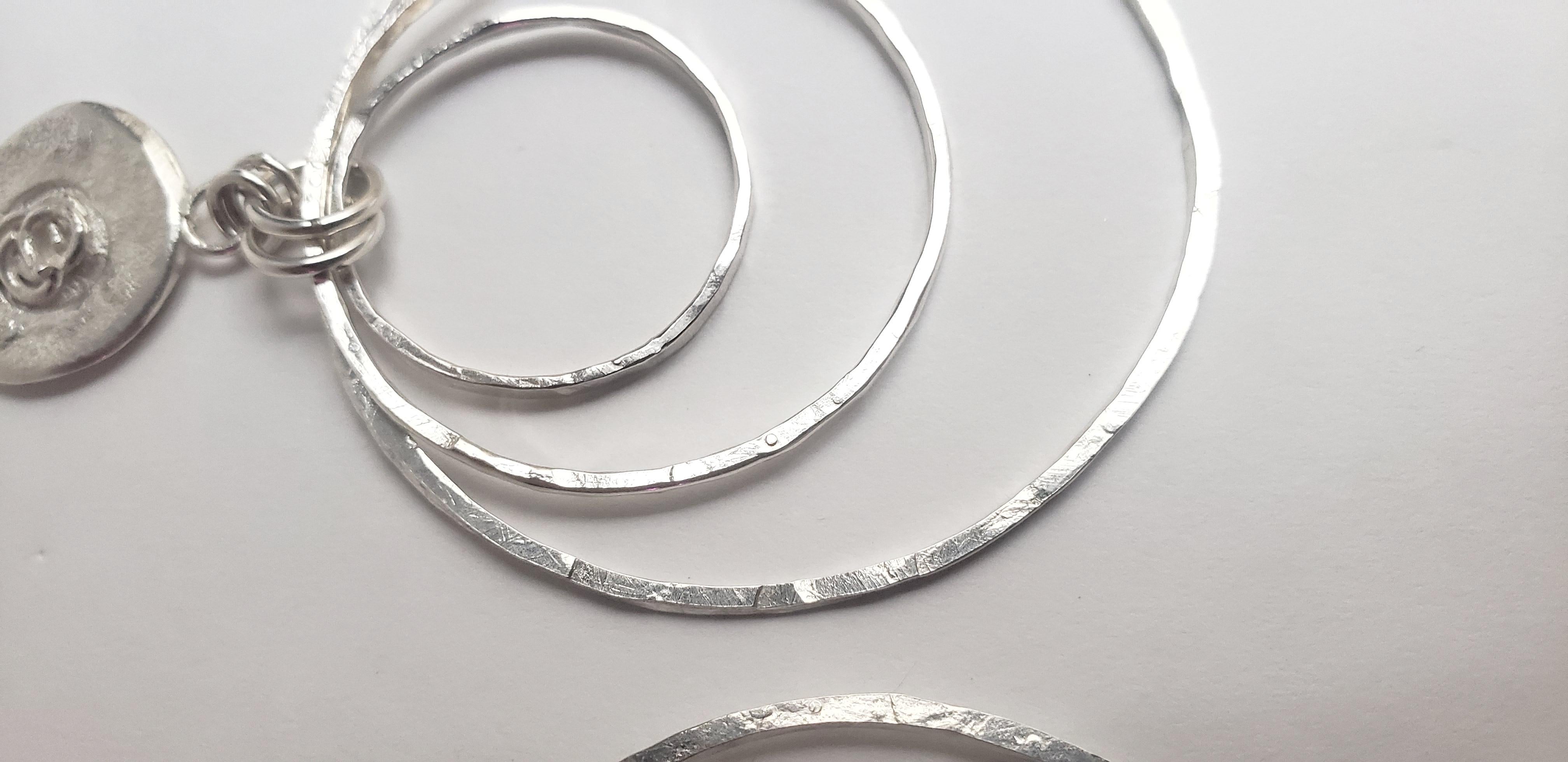These handcrafted earrings are a beautiful combination of three-layered hand-hammered hoops accompanying organic volcanic textured silver MEDALLIONS.
One of the core elements of my art and jewels is MEDALLION. Each MEDALLION is created through a