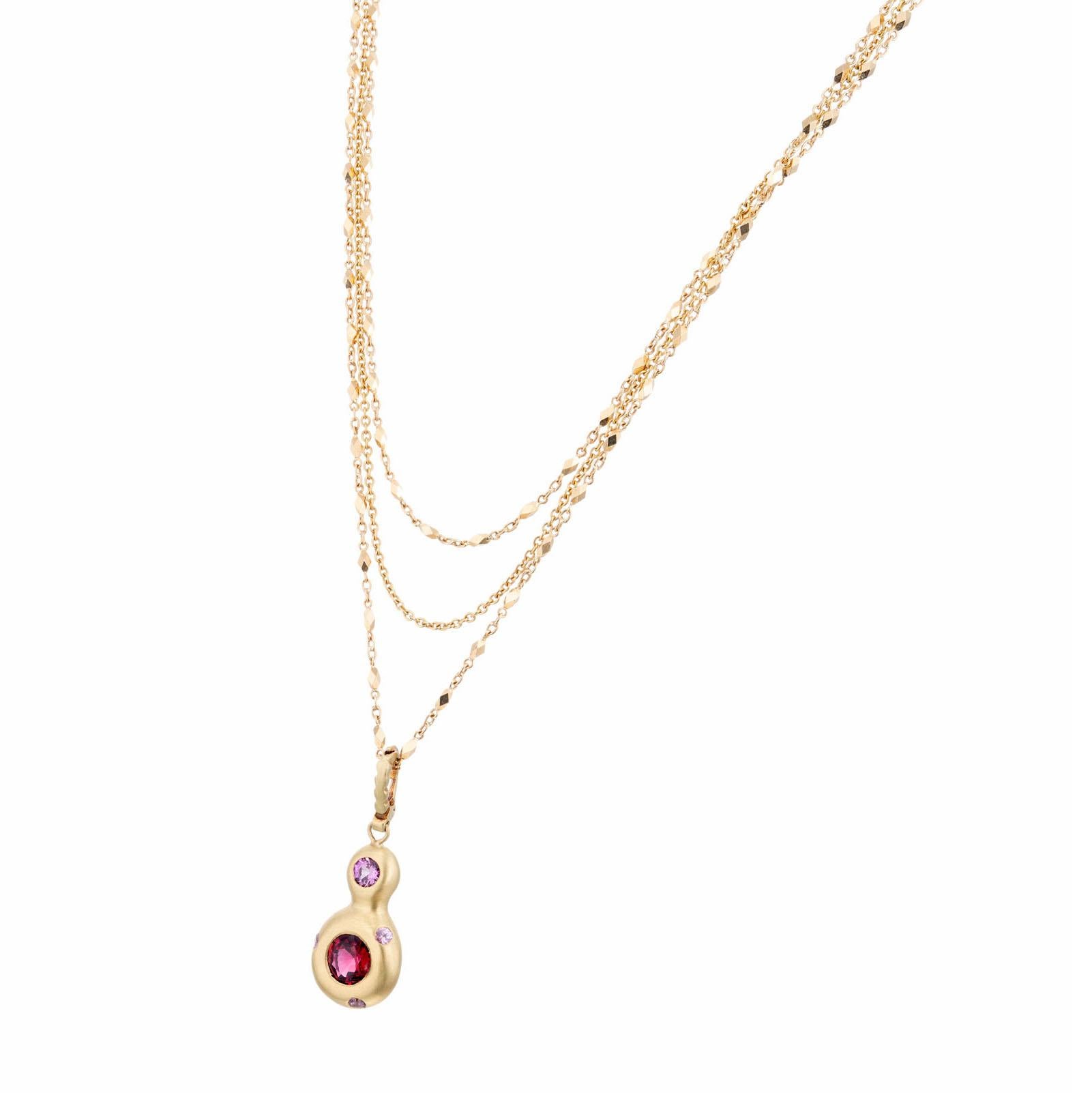 GIA Certified natural red Burma spinel 18k yellow gold Robin Rotenier pendant necklace. Red spinel with a purple accent sapphires. Pendant stamped RR.

1 round red spinel VS, approx. 1.32cts GIA Certificate # 2205737452
1 round deep pink sapphire,
