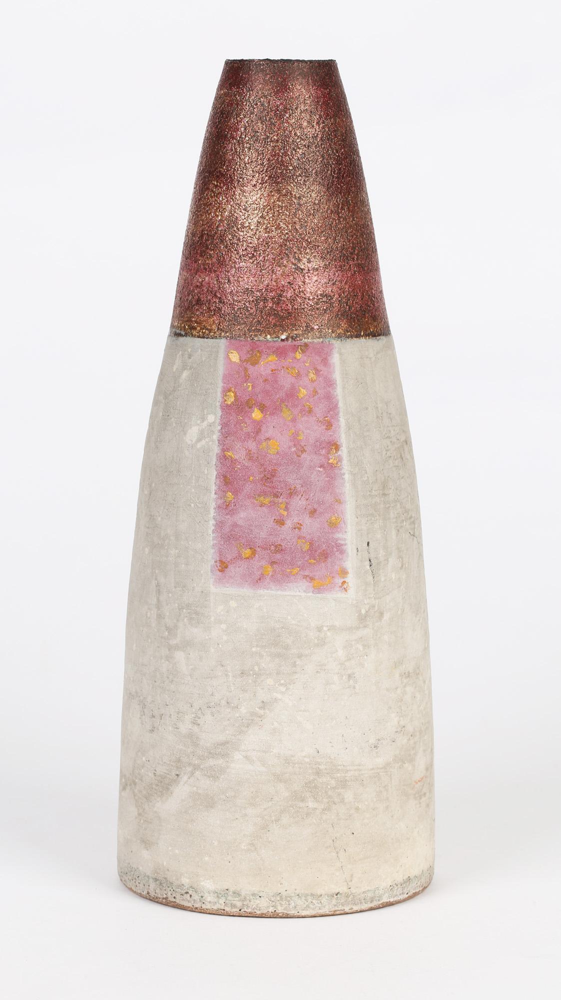 A stylish vintage British studio pottery stoneware vase of simple graduated rounded shape decorated in grey, pink and textured glazes by renowned potter Robin Welch and dating from the 20th century. The tall vase stands on a wide rounded foot and