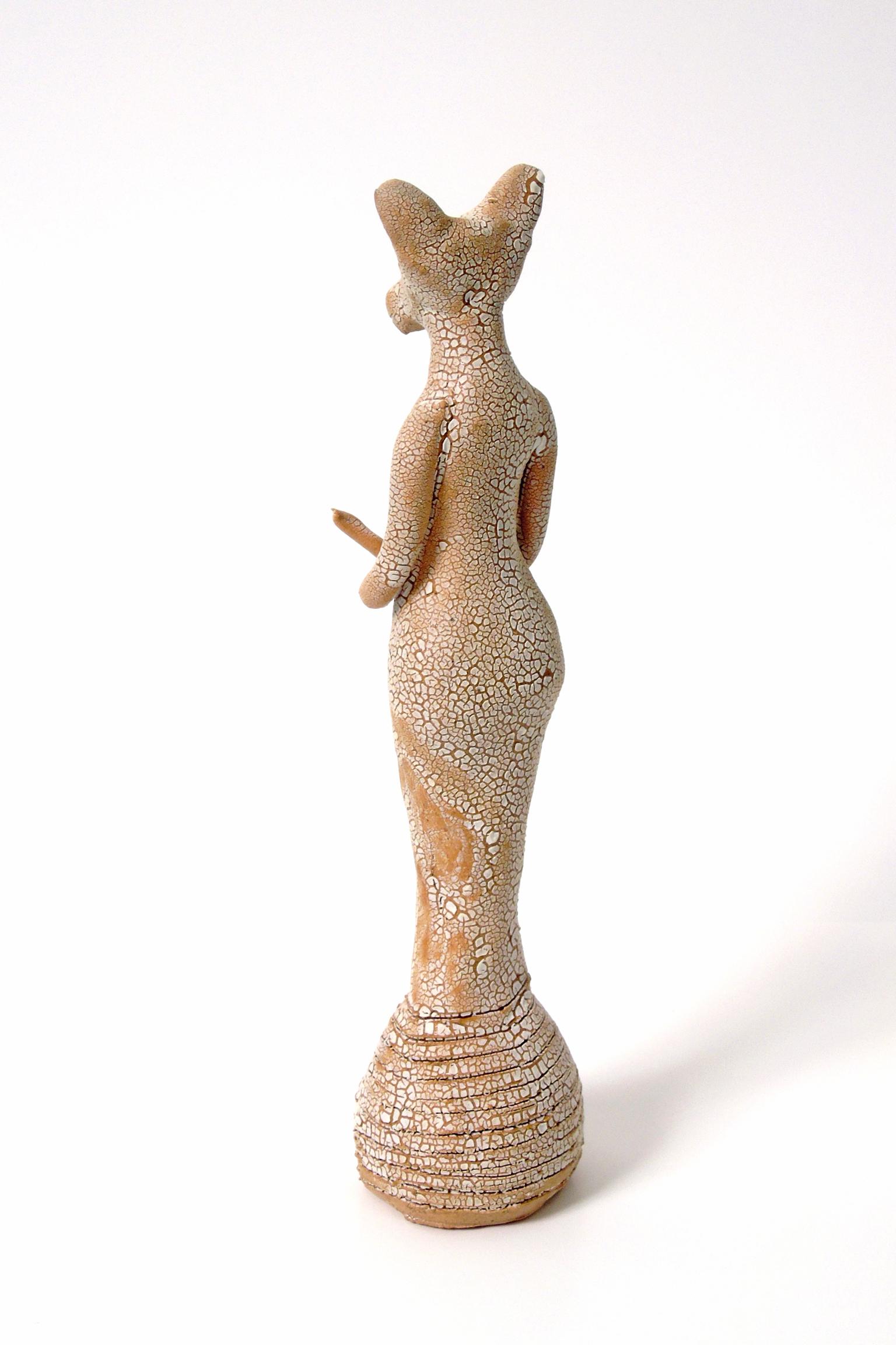 Tiny Fox Totem -82, by Robin Whiteman, in brown terracotta and crackled white glaze is one of several figurative animal totems currently available. A fox-like head is on a standing body, arms crossed at the waist. At just five and a half inches tall