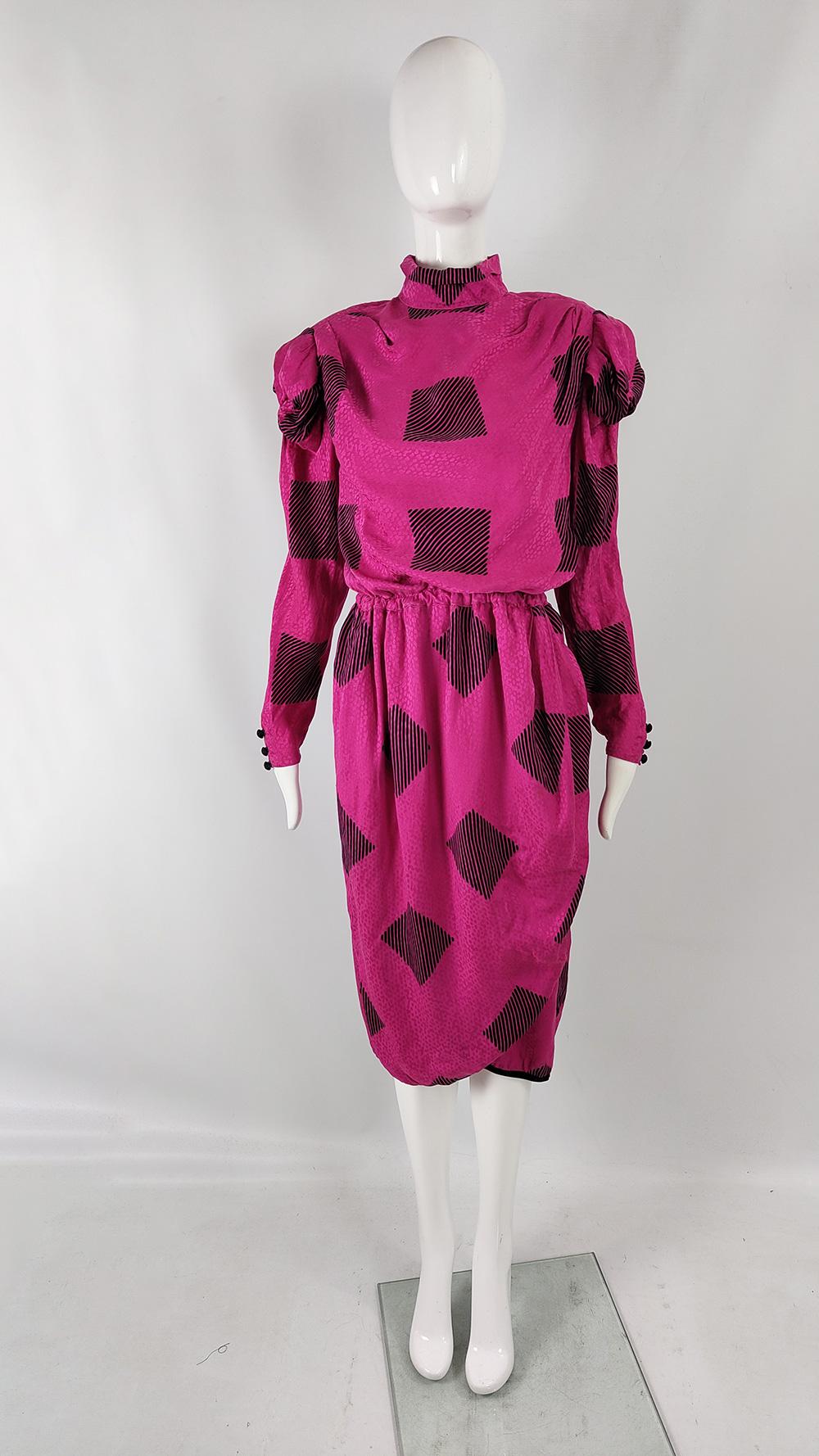 A stunning vintage womens party / evening dress from the 80s by quality Parisian designer, Robina. In a fuchsia pink silk with a satin jacquard and black geometric print throughout. The top has a typically 80s blouson fit (baggy on top with an