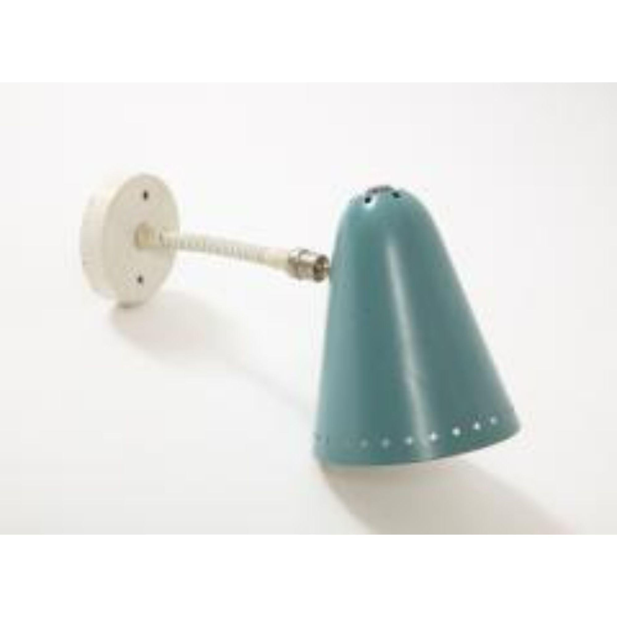Small, playful wall light in a beautifully patinated robin egg blue with punched-out star detailing around the opening.

