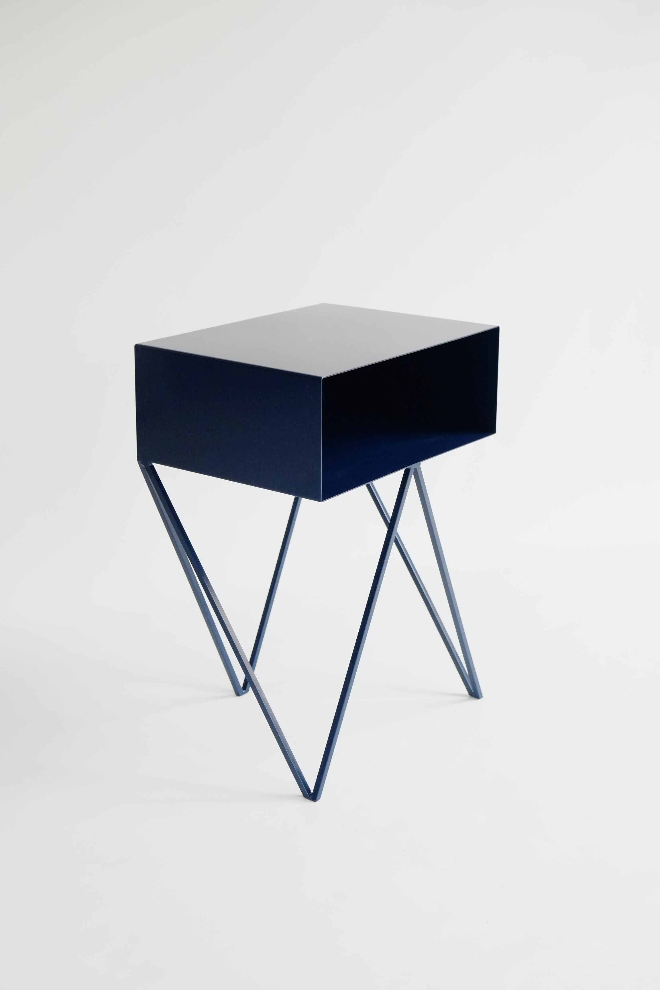 Our all-time best-seller the Robot side table features an open shelf on zig zag legs. A fun and functional design made of solid steel, powder-coated in dark blue. The clean lines look great against period details as well as in modern spaces. Perfect