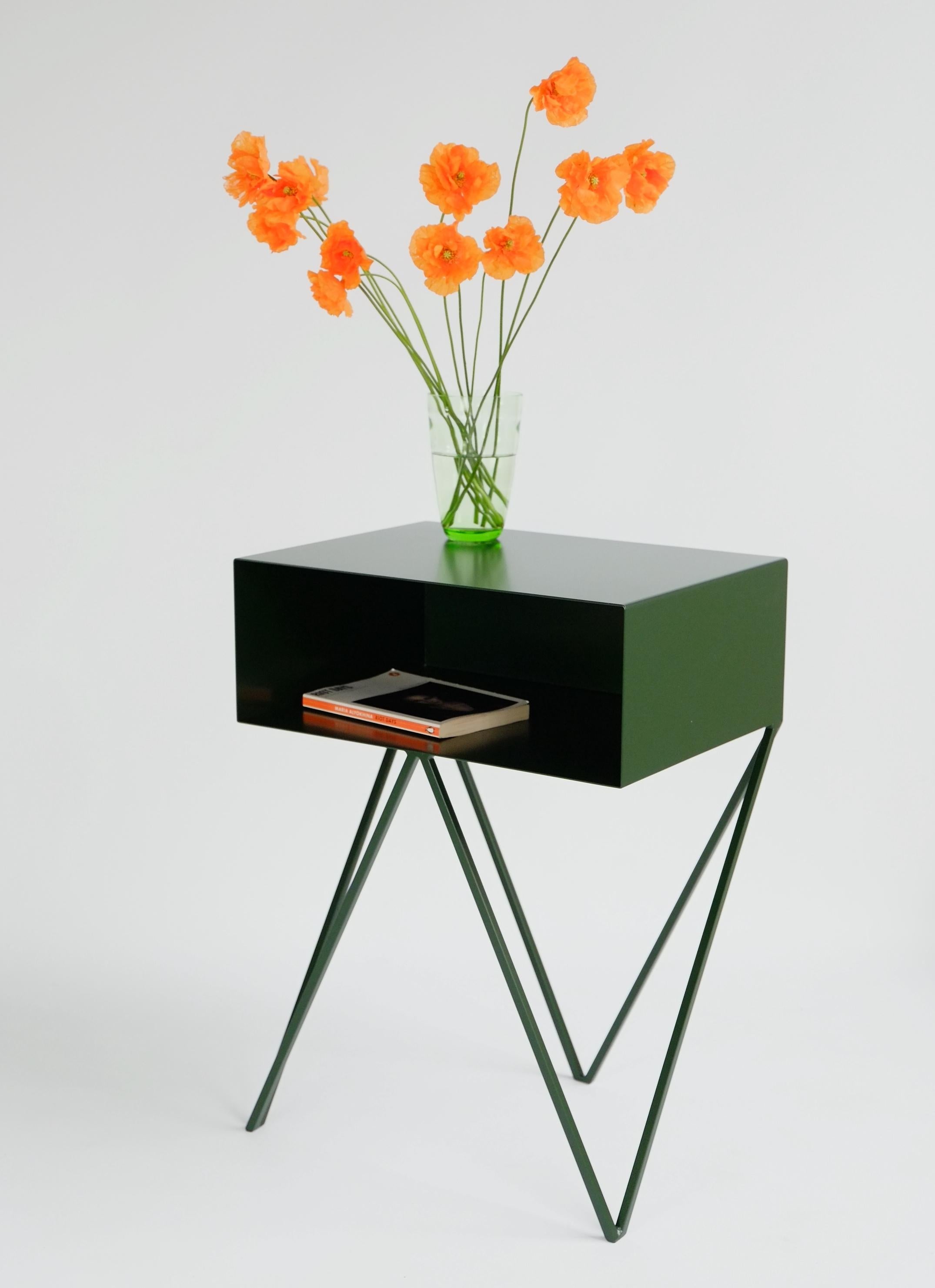 Our all-time best-seller the Robot side table features an open shelf on zig zag legs. A fun and functional design made of solid steel, powder-coated in dark green. The clean lines look great against period details as well as in modern spaces.