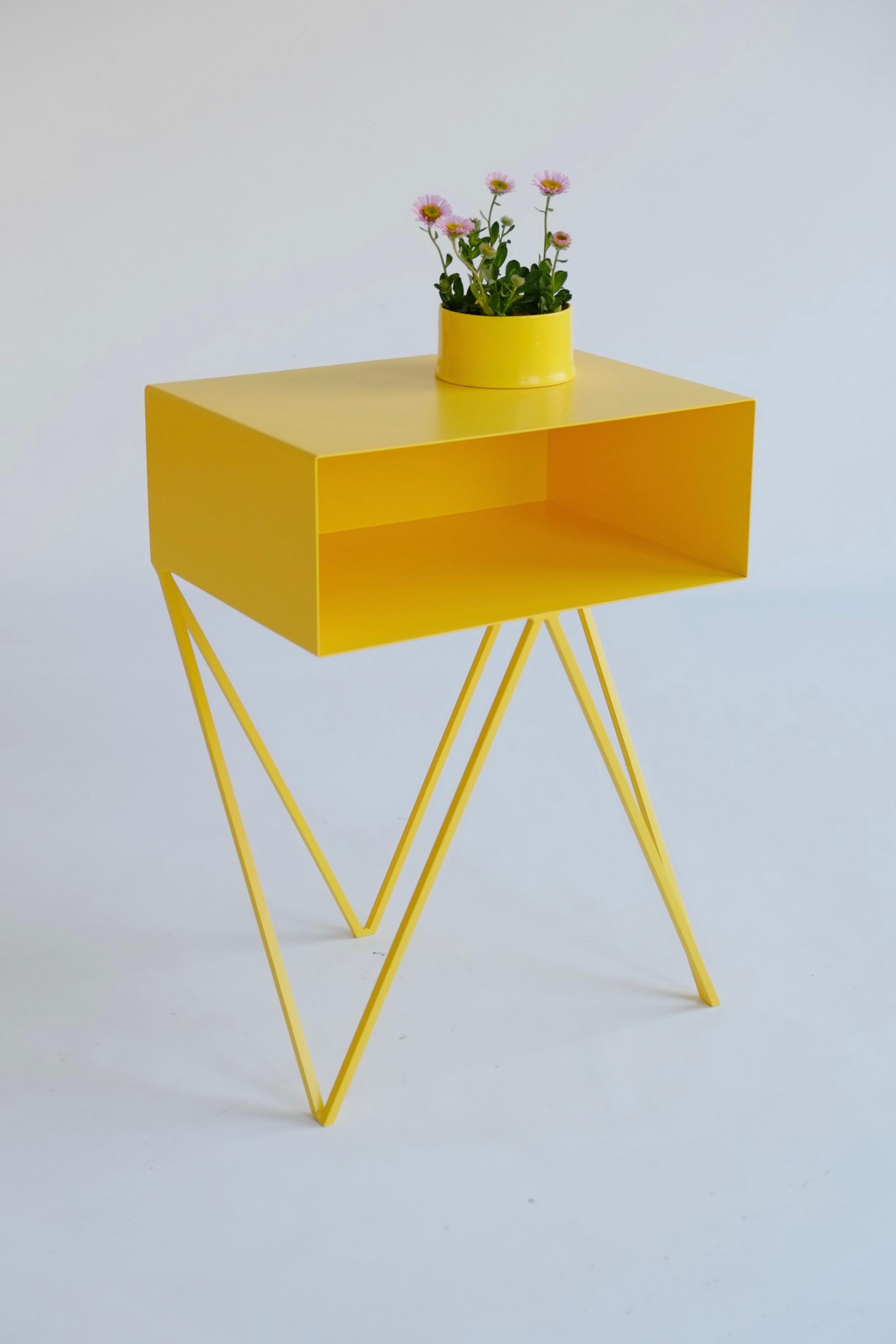 Our all-time best-seller the Robot side table features an open shelf on zig zag legs. A fun and functional design made of solid steel, powder-coated in yellow. The clean lines look great against period details as well as in modern spaces. Perfect as