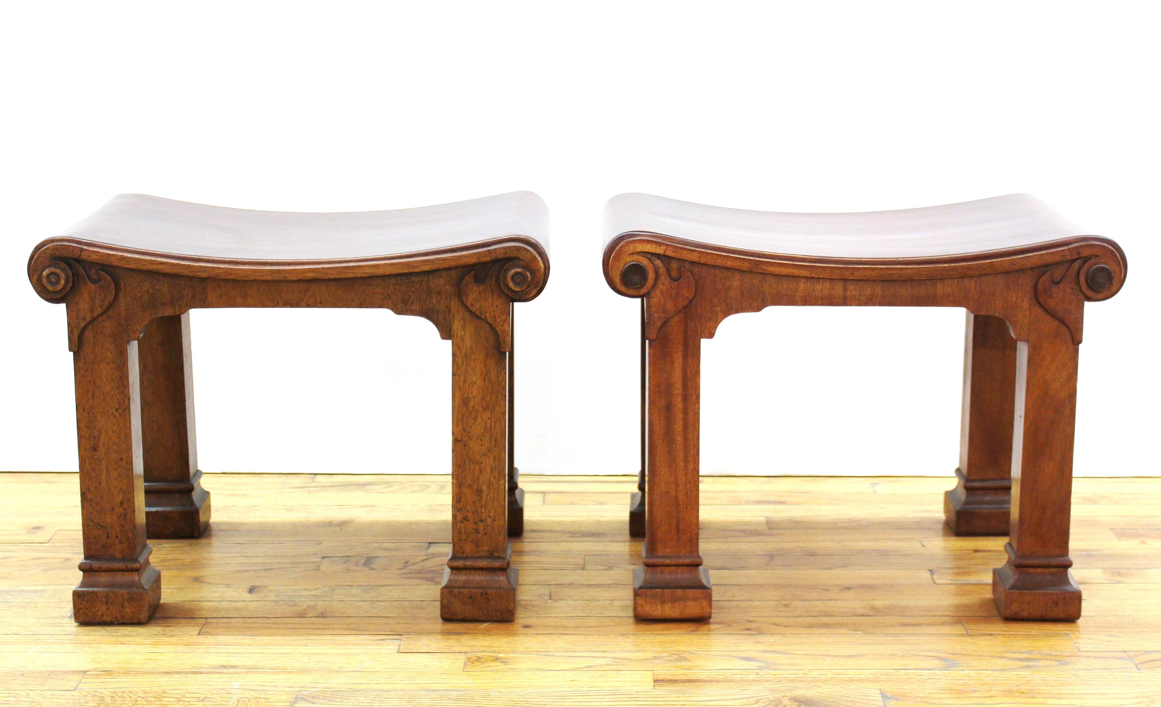 Neoclassical Revival style pair of carved wood benches attributed to T. H. Robsjohn Gibbings, showing decorative elements of the Greek Klismos style.