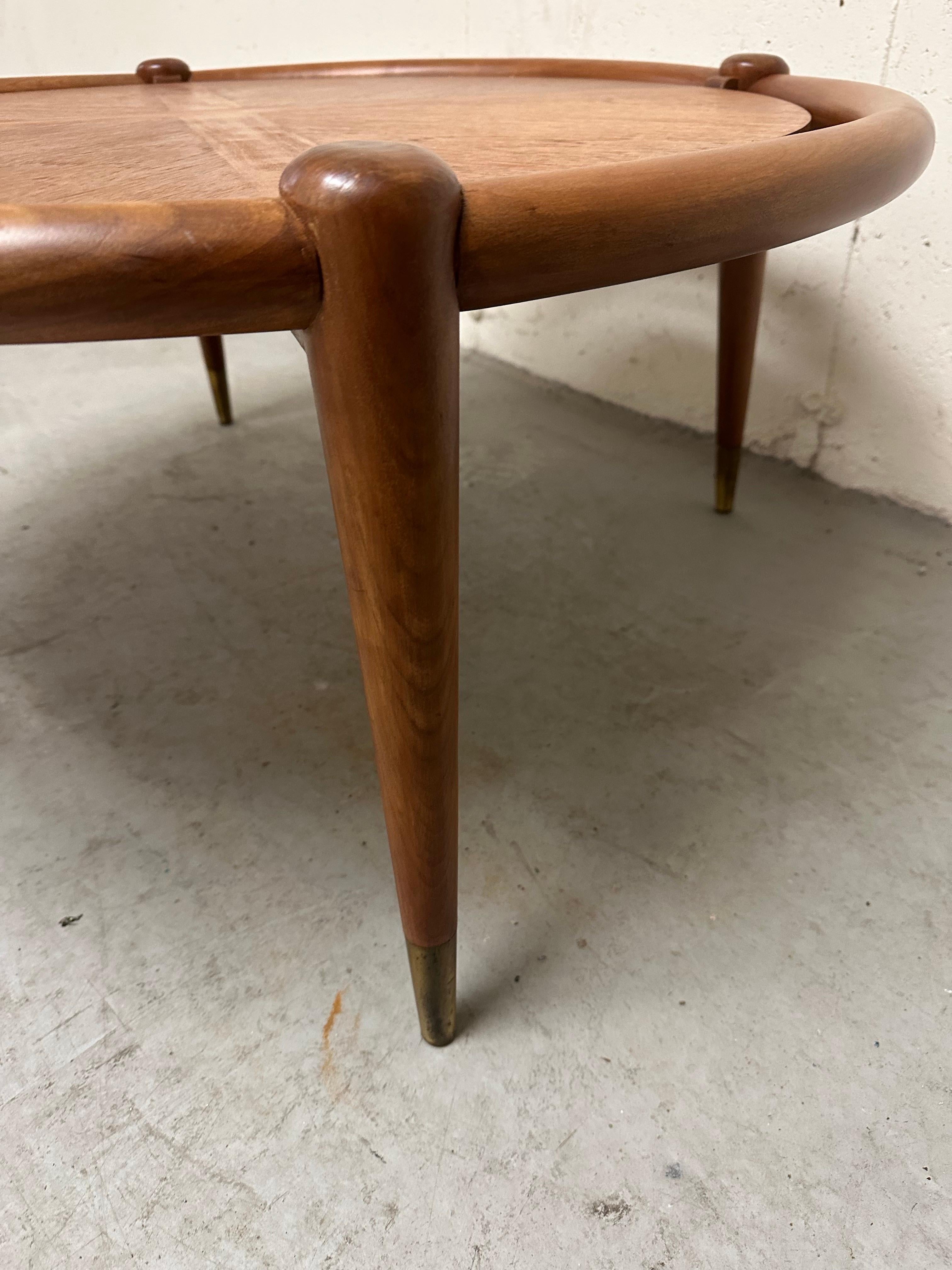 Beautiful Widdicomb coffee table by Robsjohn-Gibbings with brass sabots on 4 tapered legs.