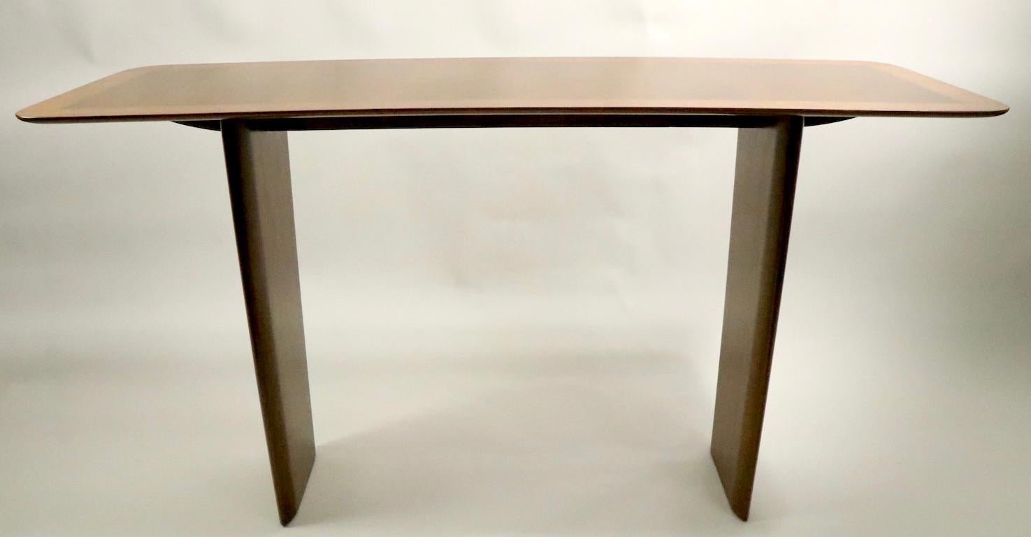 Rare Robsjohn Gibbings console table in beautiful professionally restored finish. Elegant knife blade edge, with sophisticated banded inlay veneer top This model is extremely hard to find, it is fully and correctly marked, clean and ready to use.