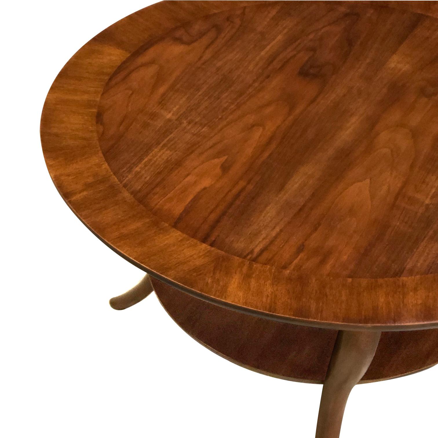 The well-figured circular top raised on elegantly splayed supports all joined by a lower shelf; excellent vintage condition.