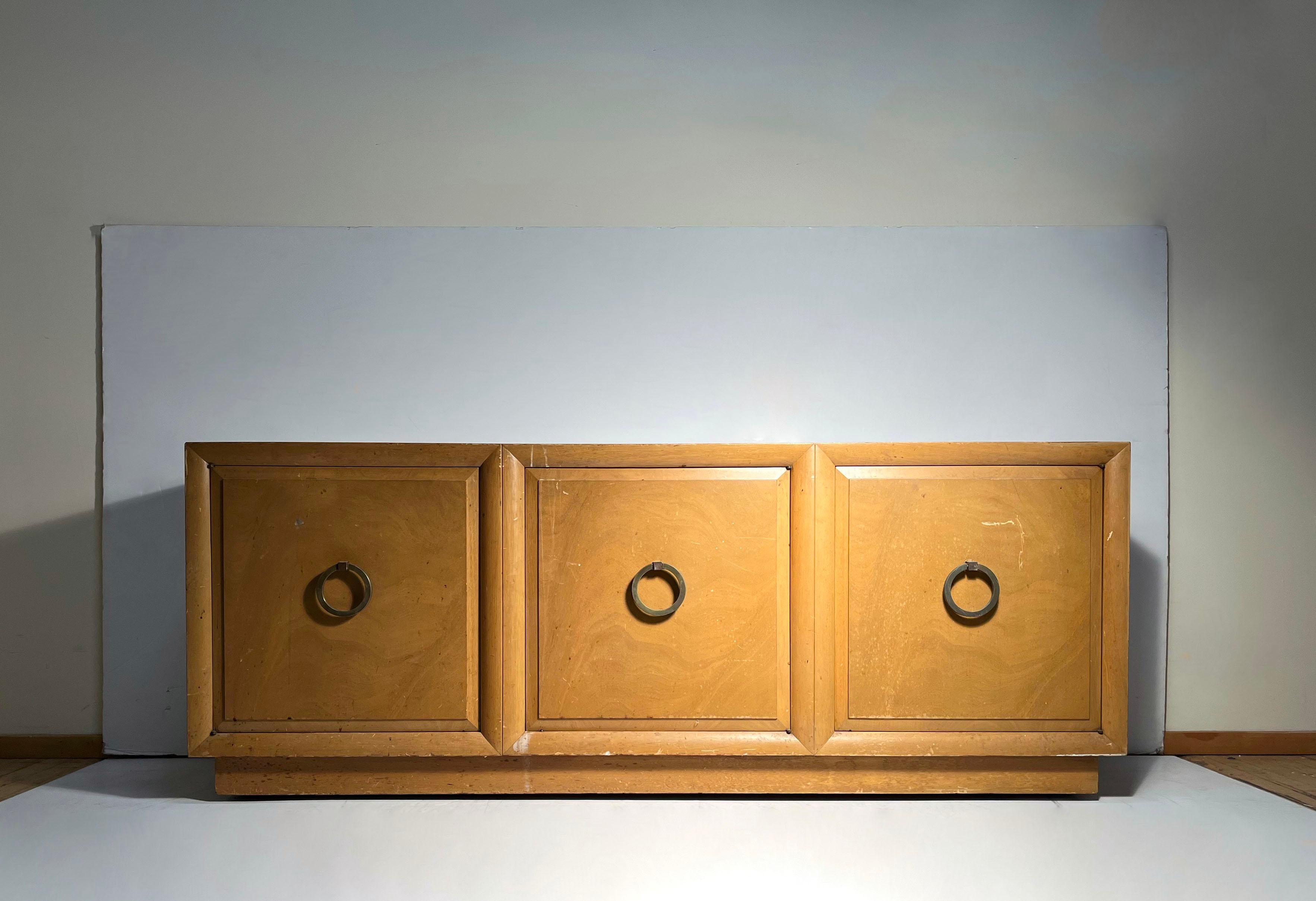 Robsjohn Gibbings Sideboard Credenza Cabinet w Large Ring Pulls

3 open spaces behind each door with the option to use adjust shelves (not included). Manufactuer predrilled holes for shelf supports. 

This item will require refinishing. Looks to be