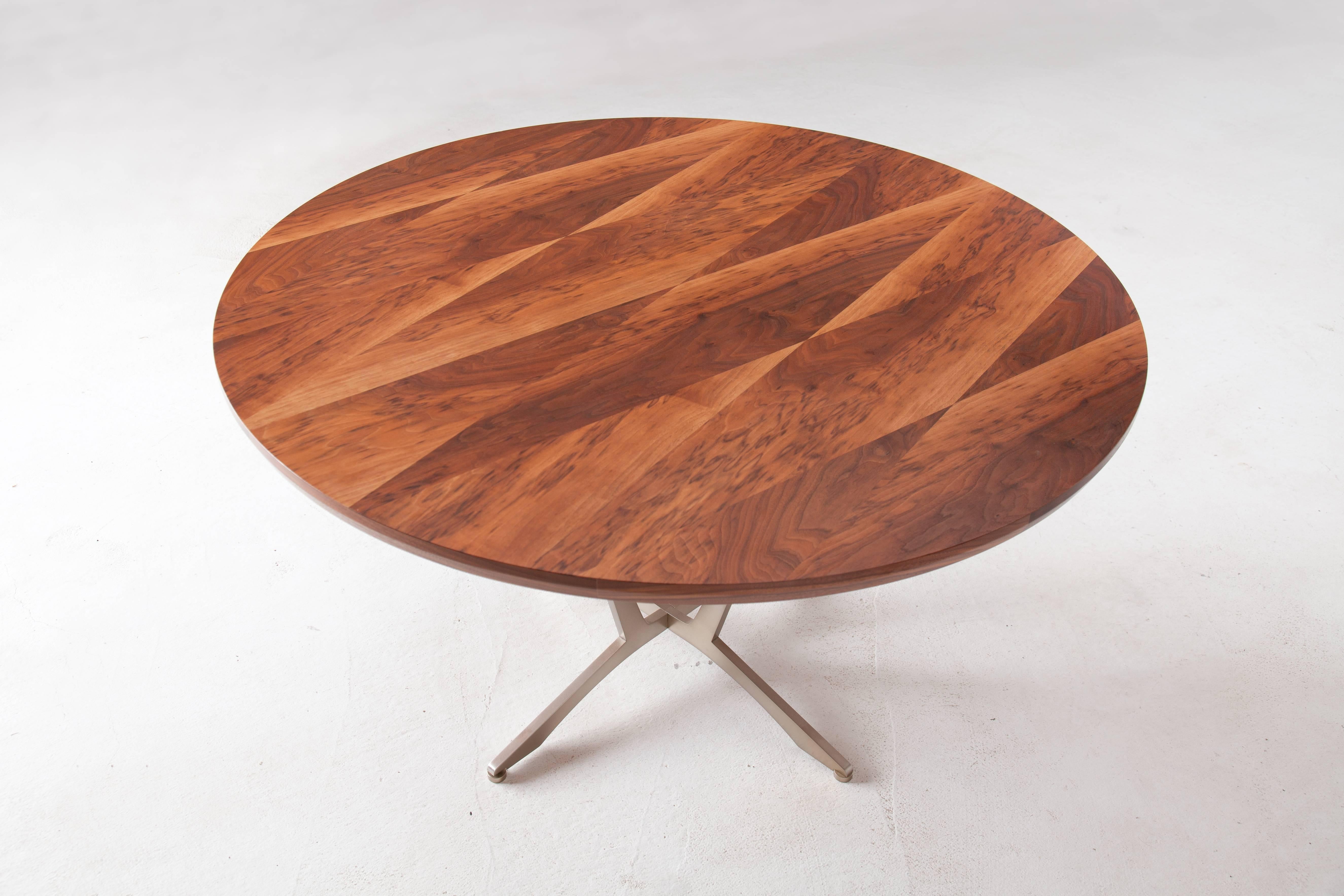 The Robson Table has a classic circular shape and elegant woodwork. Available in a variety of American hardwoods with surface patterns ranging from simple flat sawn to geometric (shown). Each piece is made to order, so dimensions, hardwood, pattern