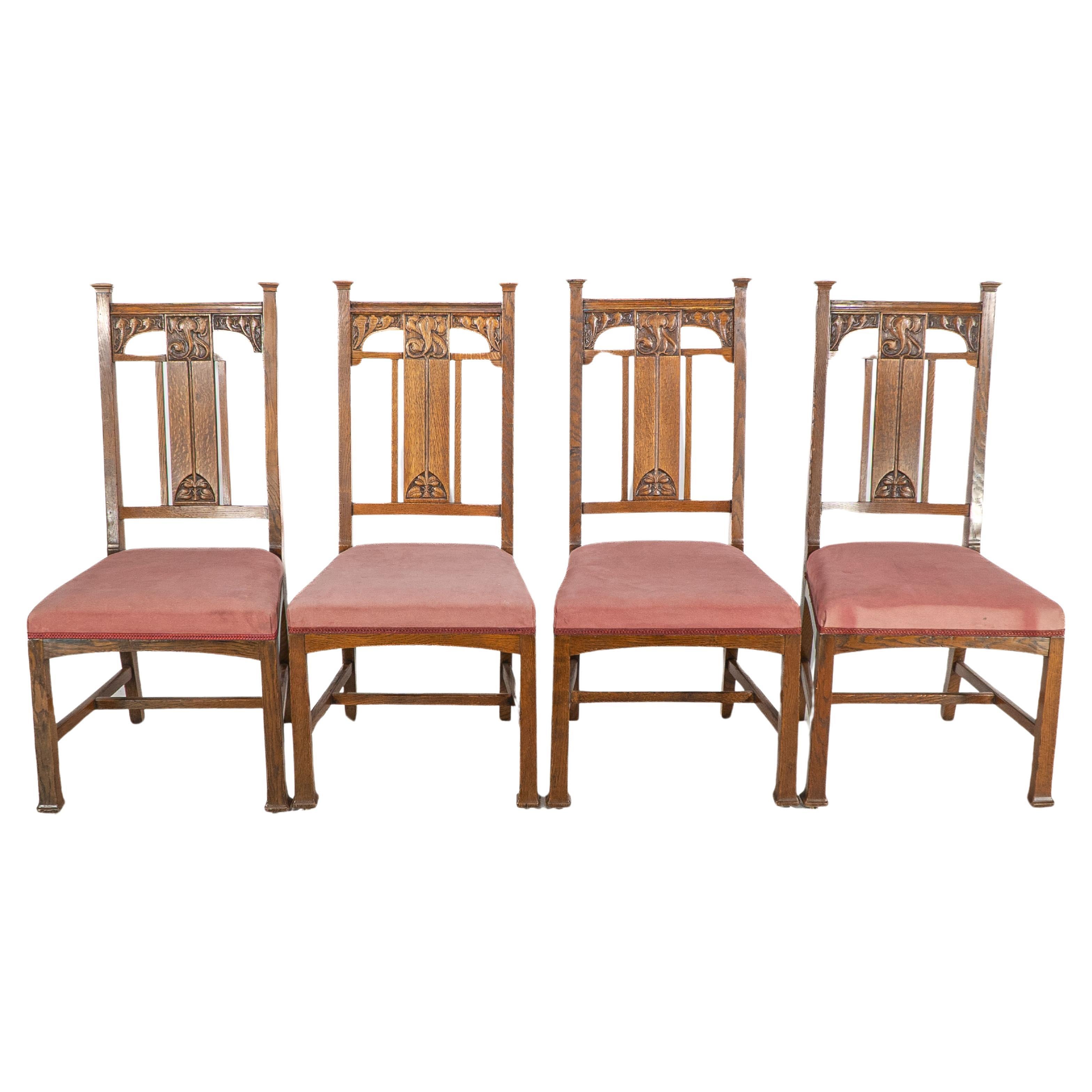 Robson & Sons. Set of 4 Arts & Crafts oak dining chairs with carved floral backs