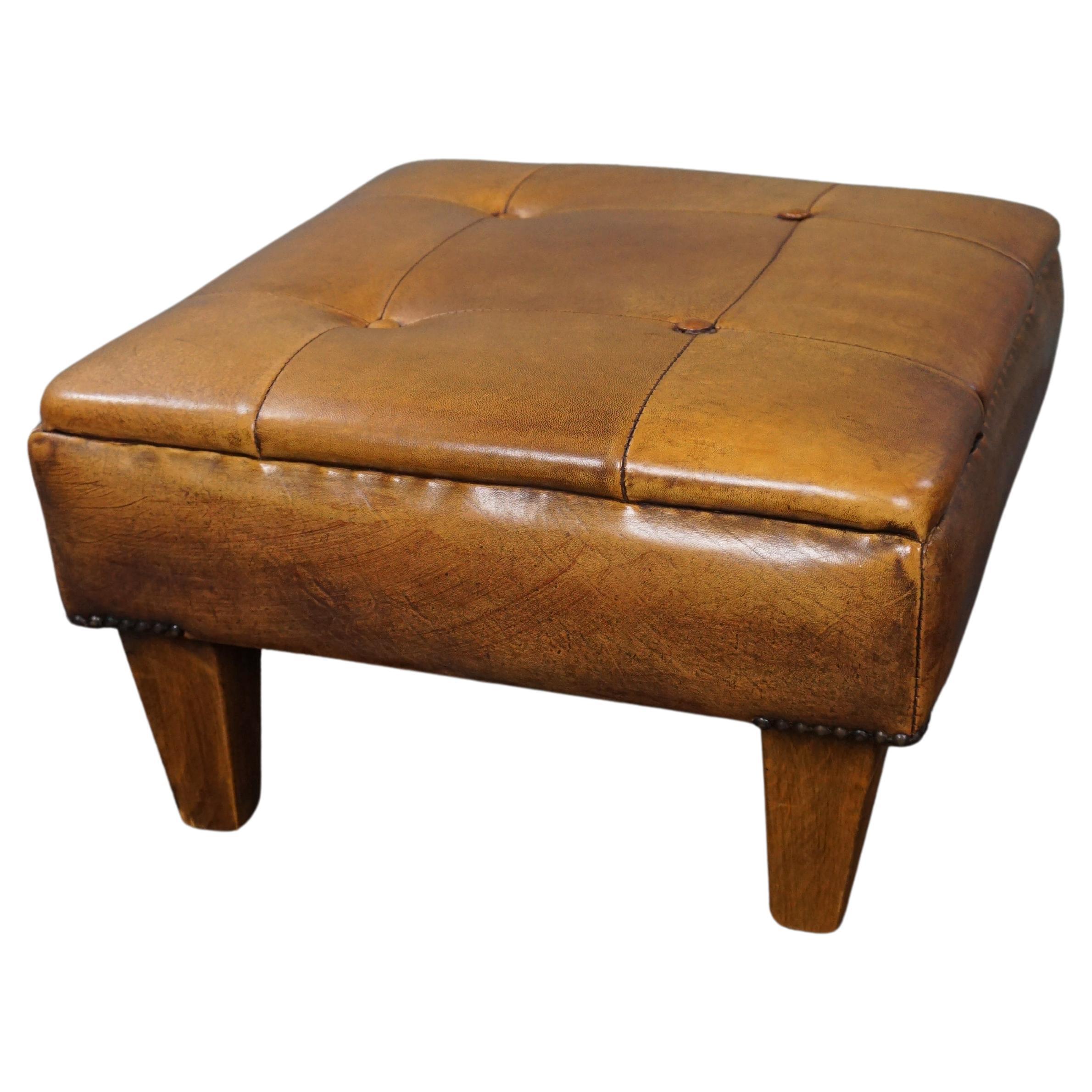 Robust button-tufted sheepskin leather ottoman